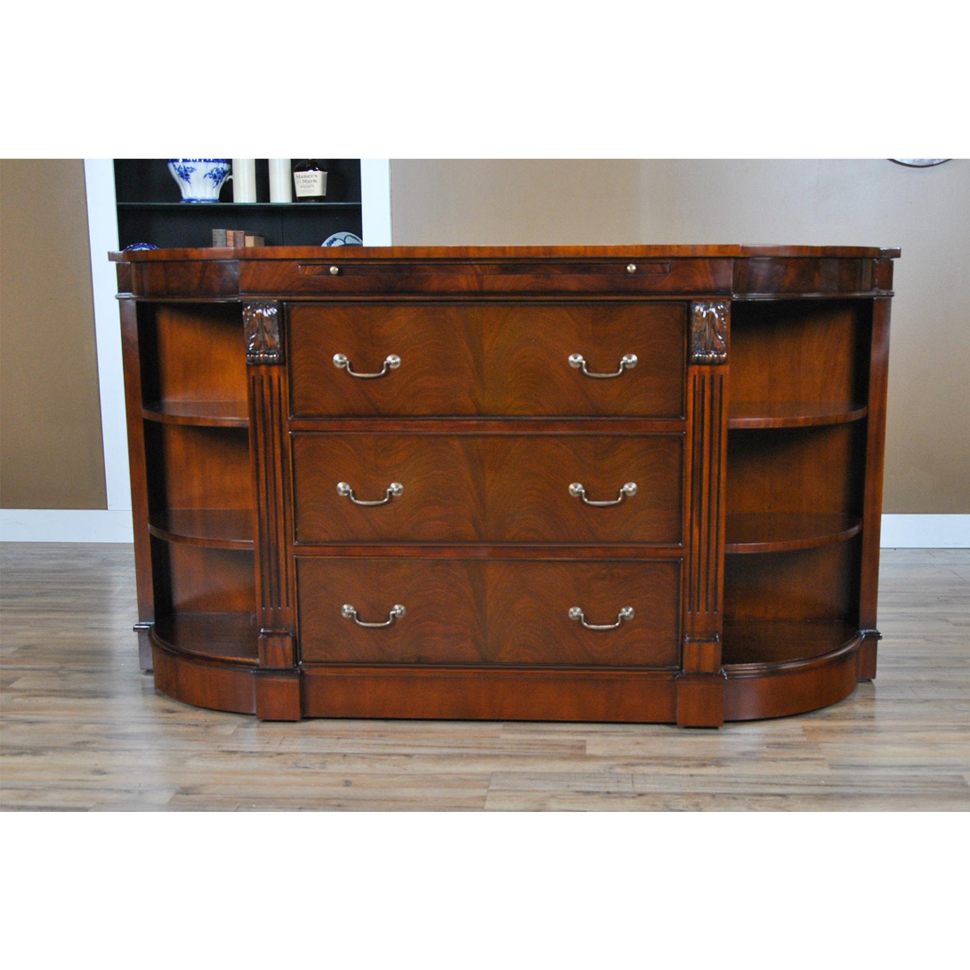 The Niagara Furniture Mahogany Credenza with Pullout Slide. This stylish piece has fantastic details throughout; including a genuine full grain leather inset pull out tray, beautiful, solid brass drawer pulls, hand carved solid mahogany carvings and
