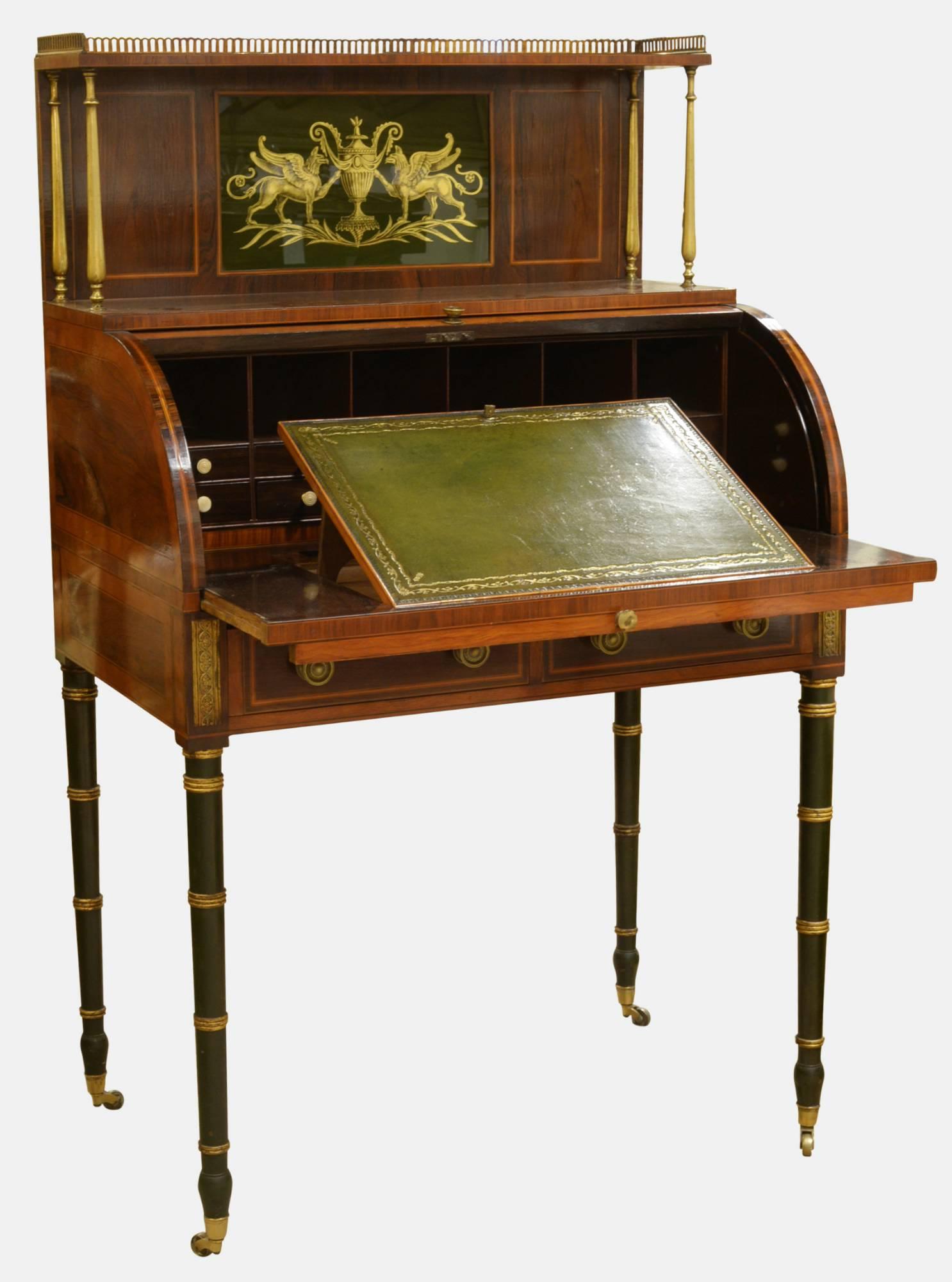 A mahogany cylinder desk with églomisé panel to the back. In the manner of John Maclean,

circa 1810.