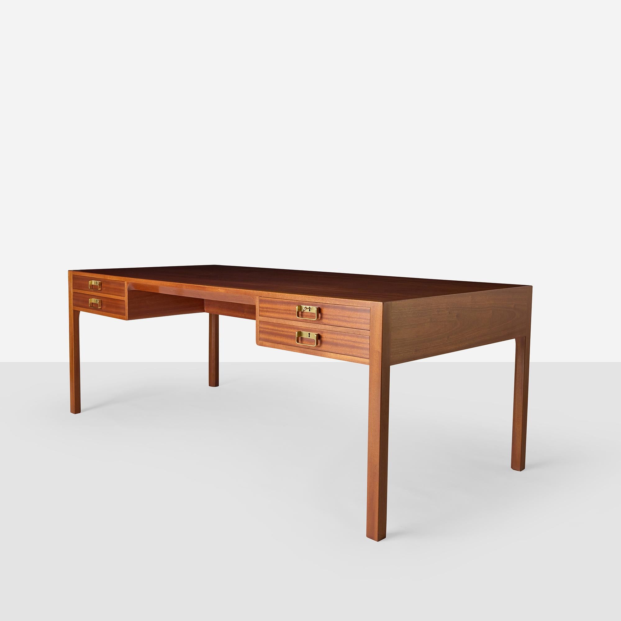 This generously proportioned mahogany desk by Bernt Petersen for Dansk Møbelkunst features four drawers with brass campaign-style hardware, clean lines, and elegant proportions. Key included.

Very good condition with light use.