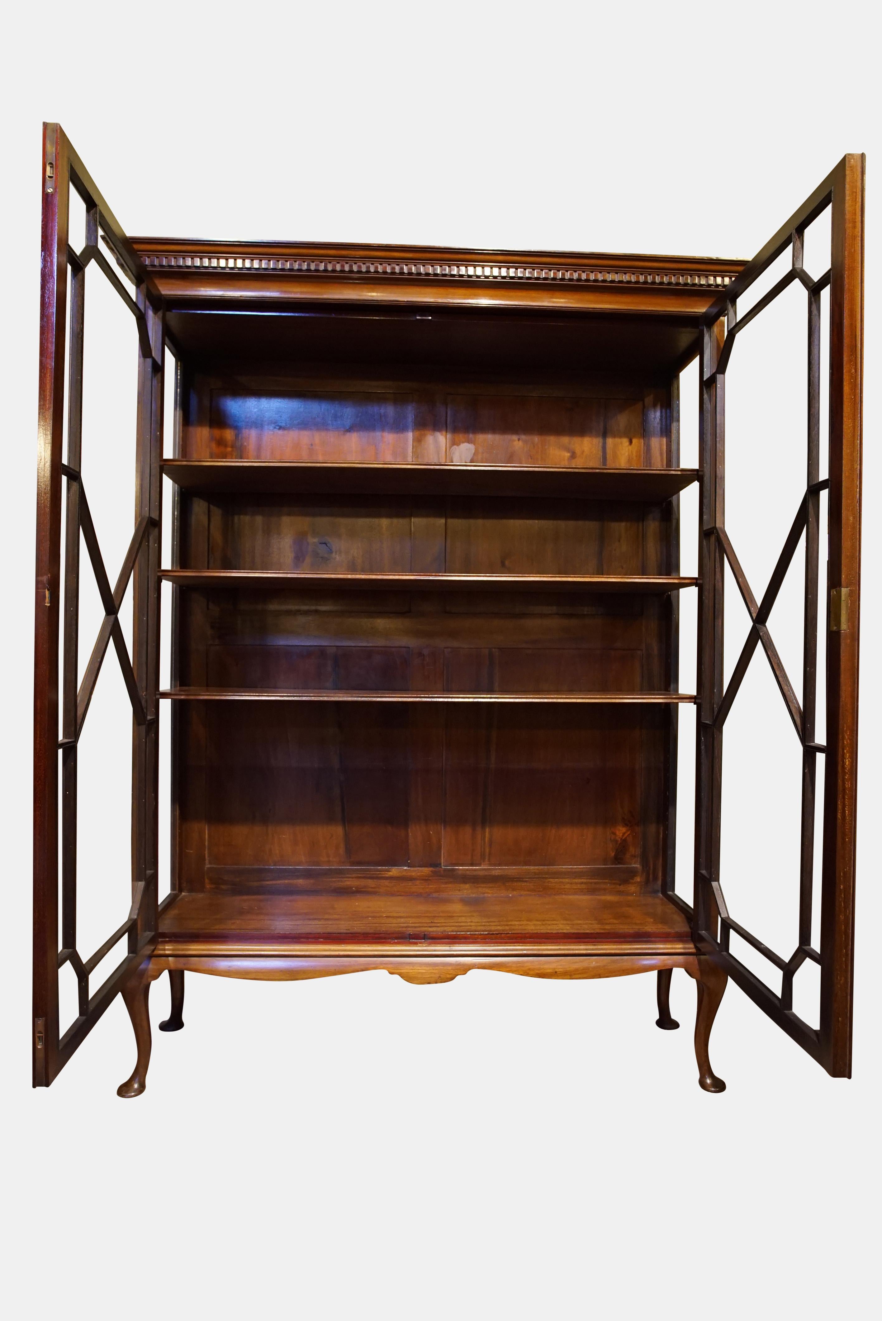 A mahogany astragal-glazed display cabinet standing on cabriole legs and pad feet,

circa 1900.
   