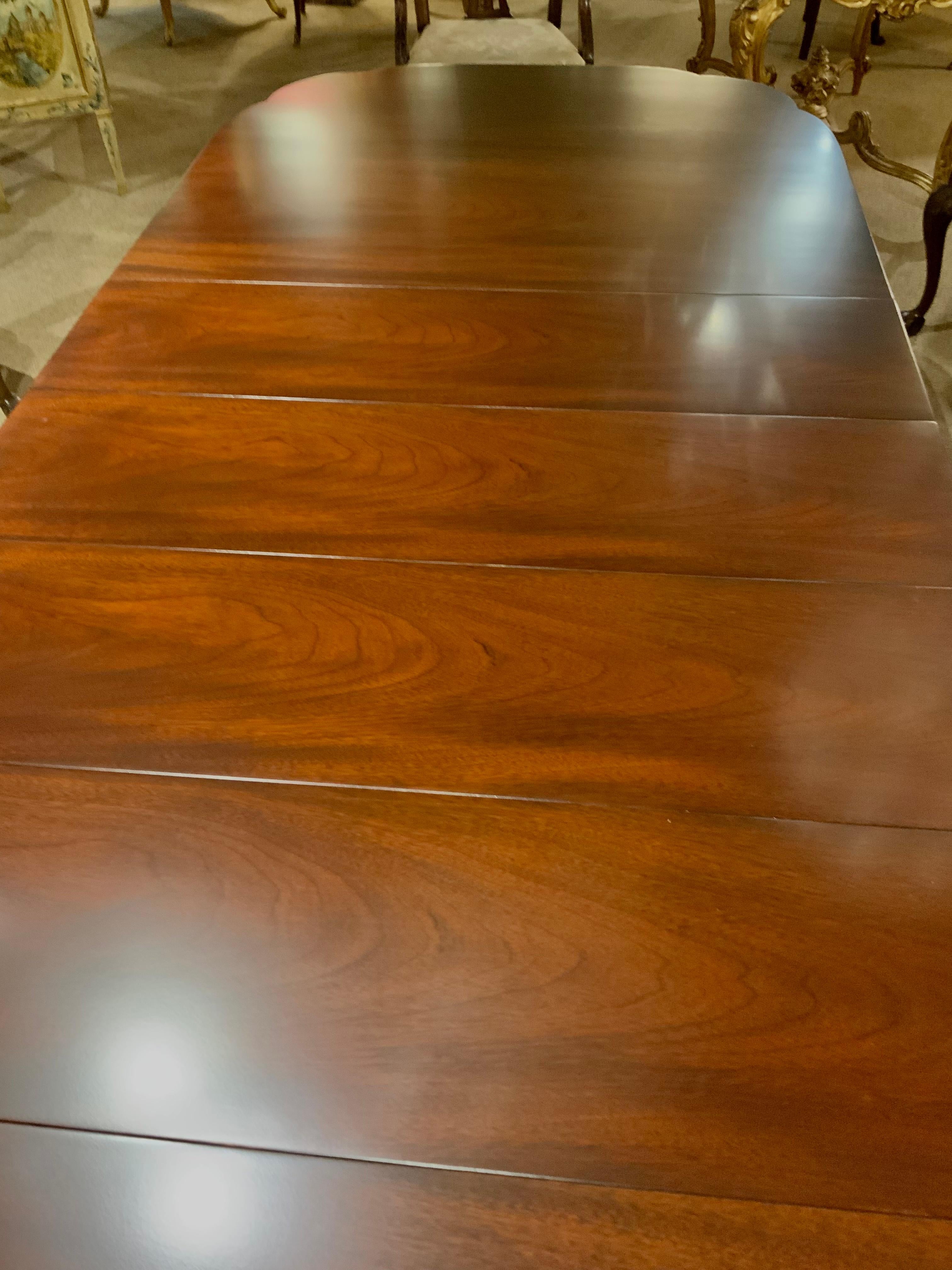 The wood in this table is in exceptional condition and the top is without
Scratches. The D shaped ends are slightly scalloped on the corners.
It has four leaves that slide easily and can be removed to adjust the length. It is
126” fully extended and