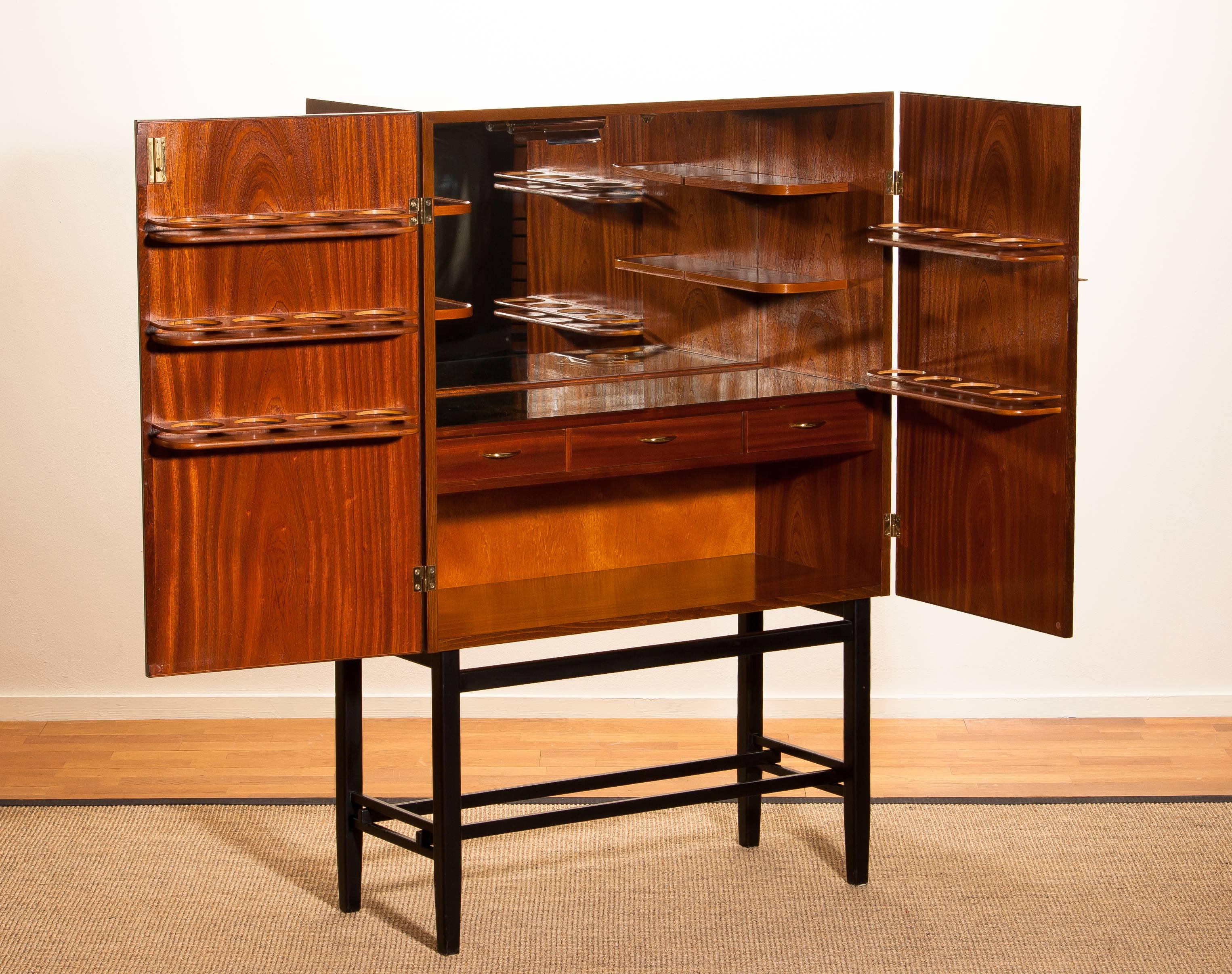Mid-20th Century Mahogany Dry Bar Cabinet, Brass Details, High Black Skinny Legs Made by Förenade