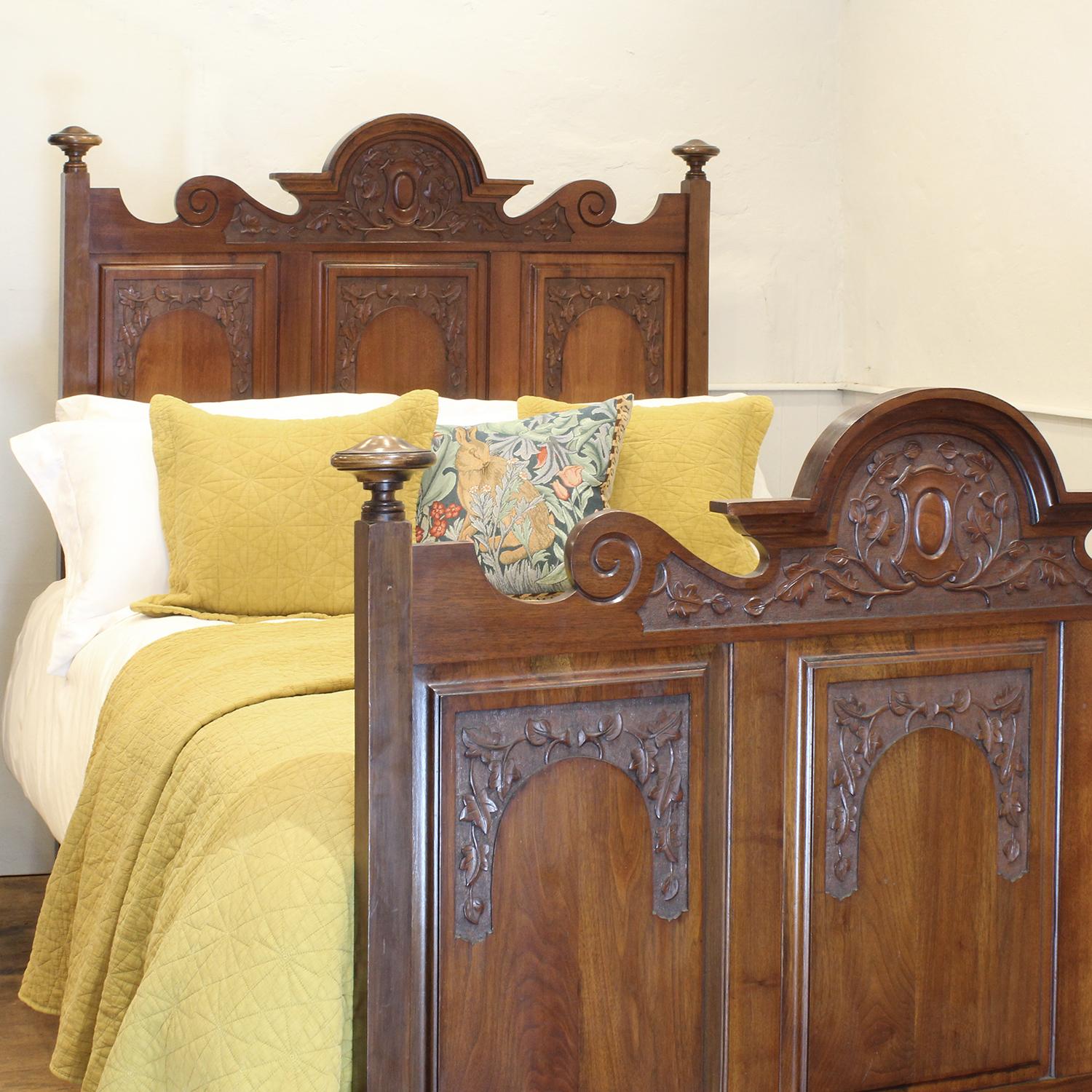 A fine Edwardian bed from walnut with superb carvings in head and foot panels.

This bed accepts a standard double, 4ft 6in (54 in), base and mattress set.

The price is for the bed frame and a firm bed base. 
The mattress, sprung bed base,