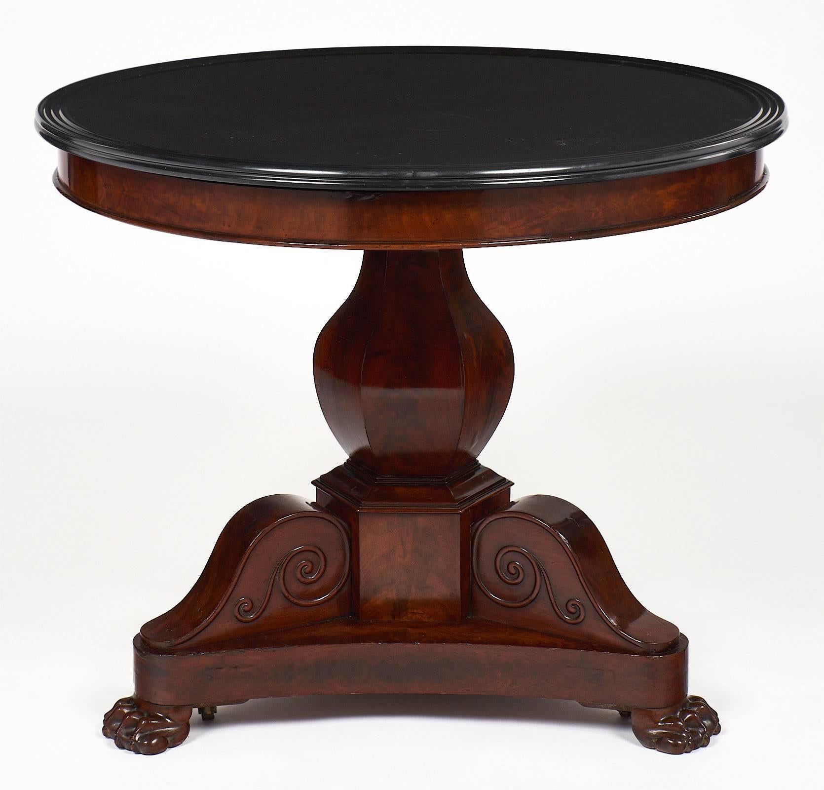A superb French Empire period mahogany gueridon with a tripod base and claw feet. This piece also has hidden casters. We love the centre tulip column. The table is topped with the original black marble, which is in excellent antique condition.