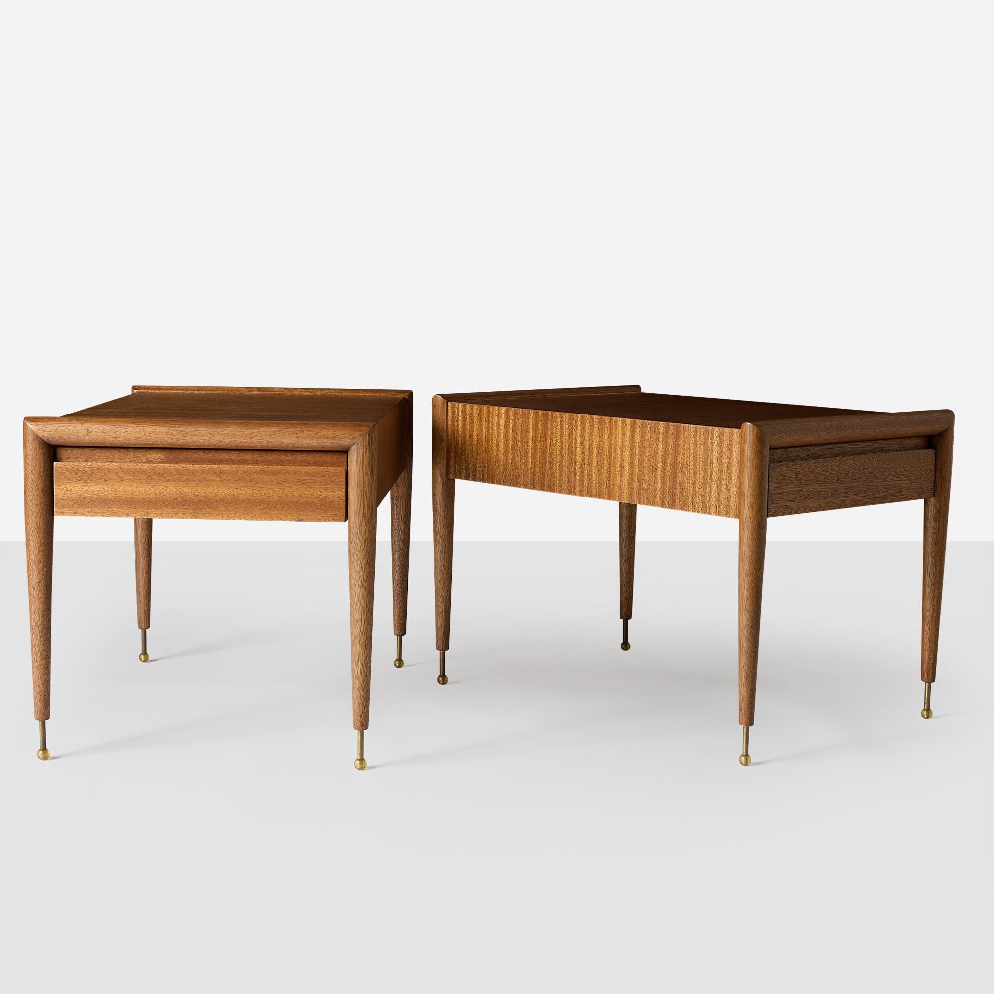 A beautifully restored pair of mahogany end tables by John Keal for Brown Saltman. Each features a single drawer and four tapered legs with round resin feet on patinated brass posts. Stamped 