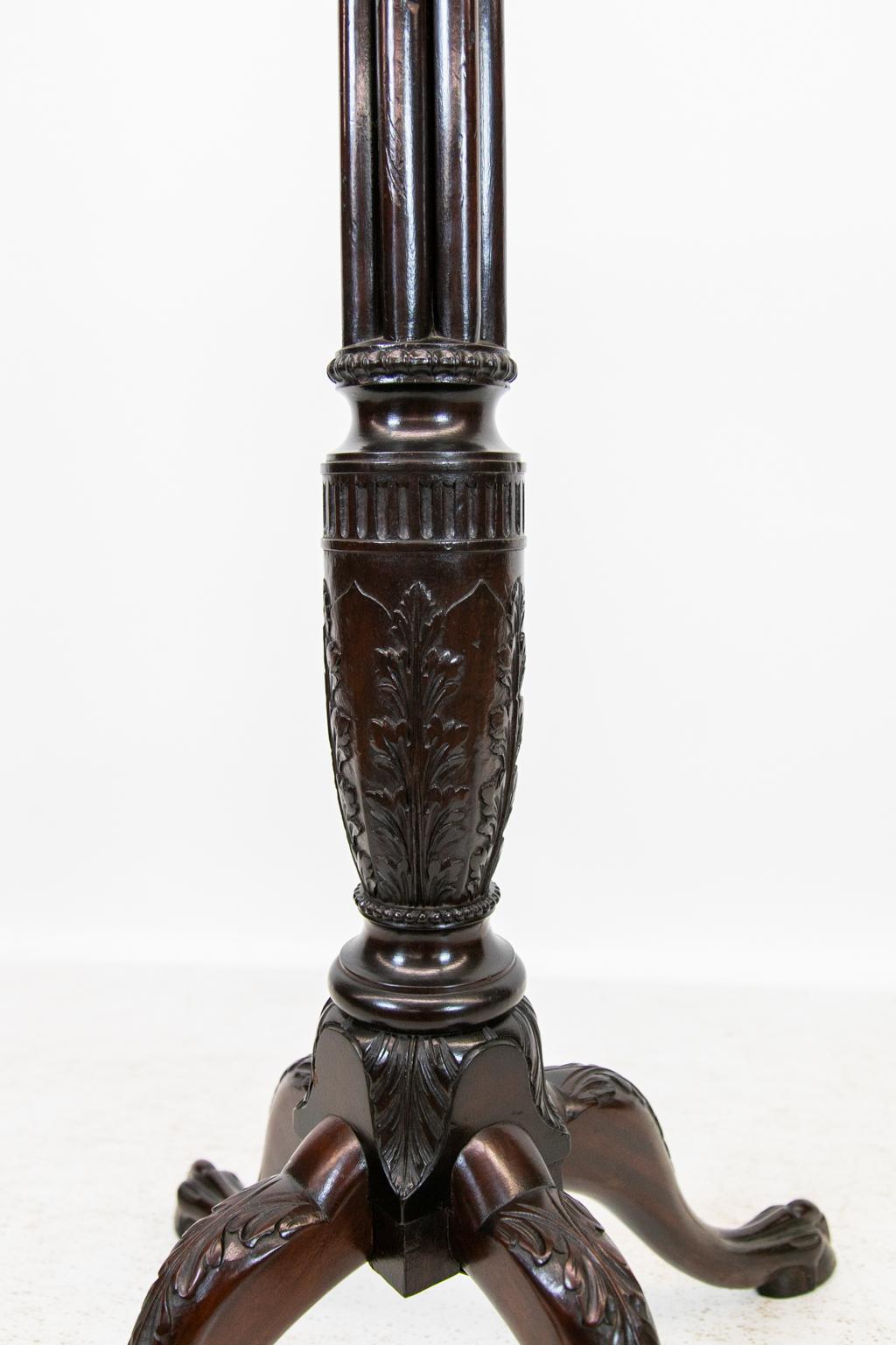 Mahogany English Chippendale plant stand, has a reeded stem with fluted acanthus carved knot terminating in four acanthus carved ball and claw legs. The top is 13.5'' square, 25'' wide at the base.
  