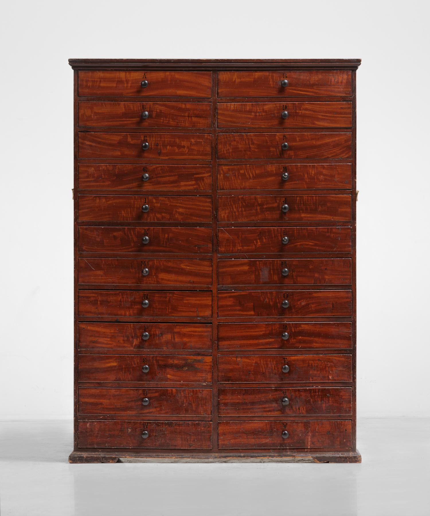 Mahogany estate chest of drawers, England, circa 1840.

Stained mahogany with wooden pulls and unique hand-painted lettering categorization system.

Measures: 49.5