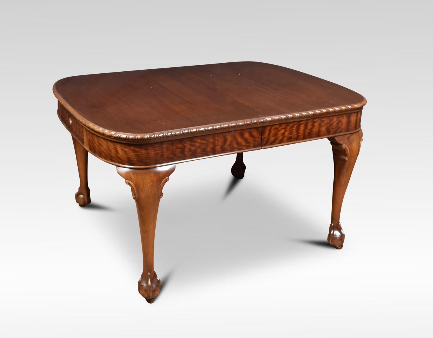 Mahogany dining table, the rectangular top with rounded corners having gadroon carved edge to the telescopic action, with solid mahogany runners opening to incorporate three leaves. All raised up on cabriole legs terminating in claw and ball