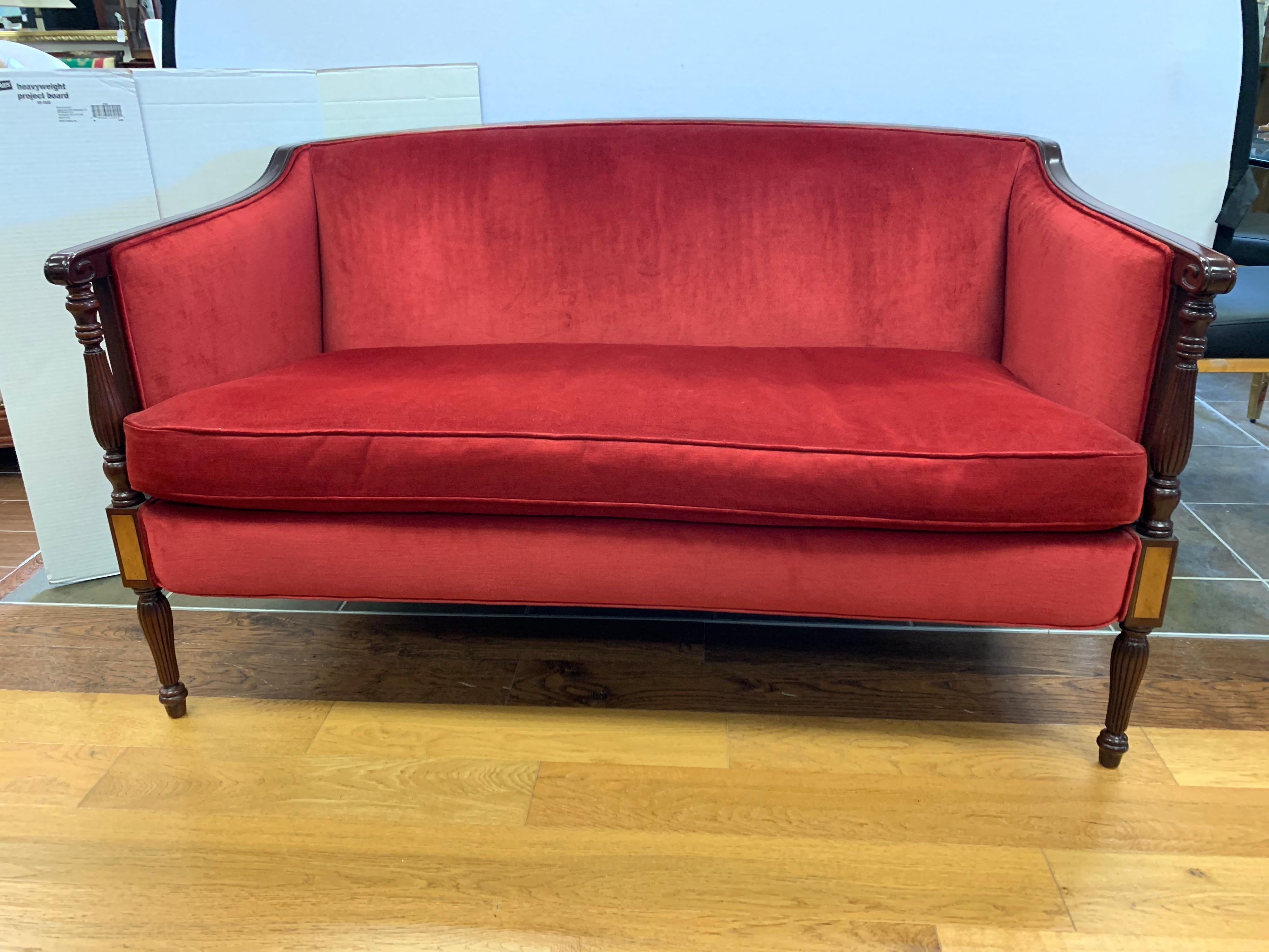 Elegant red velvet and mahogany settee loveseat with gorgeous sculptural inlay. Just the right scale.
Handmade in Hickory, North Carolina, USA with eight way hand tied construction throughout. Manufacturer is Southwood. Rarely sat in and