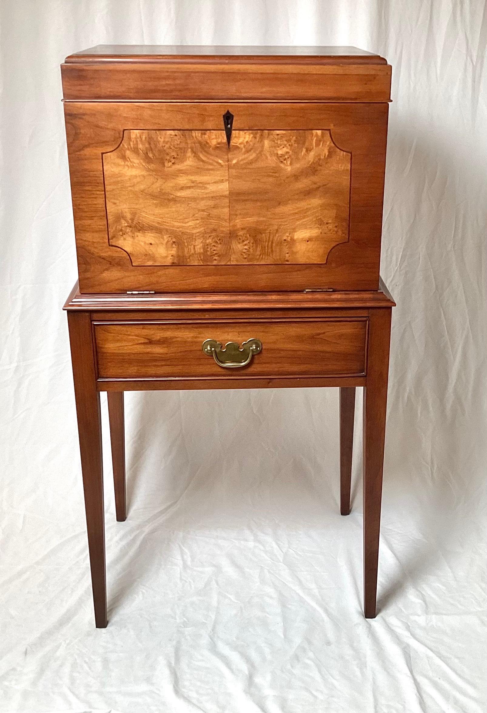 Mahogany Federal Style Silver Chest by Henkle Harris.  The medium colored mahogany with a burl center panel with lift up top to reveal several felt fitted drawers for silver flatware.  The attached base with drawer, resting on four tapering legs. 