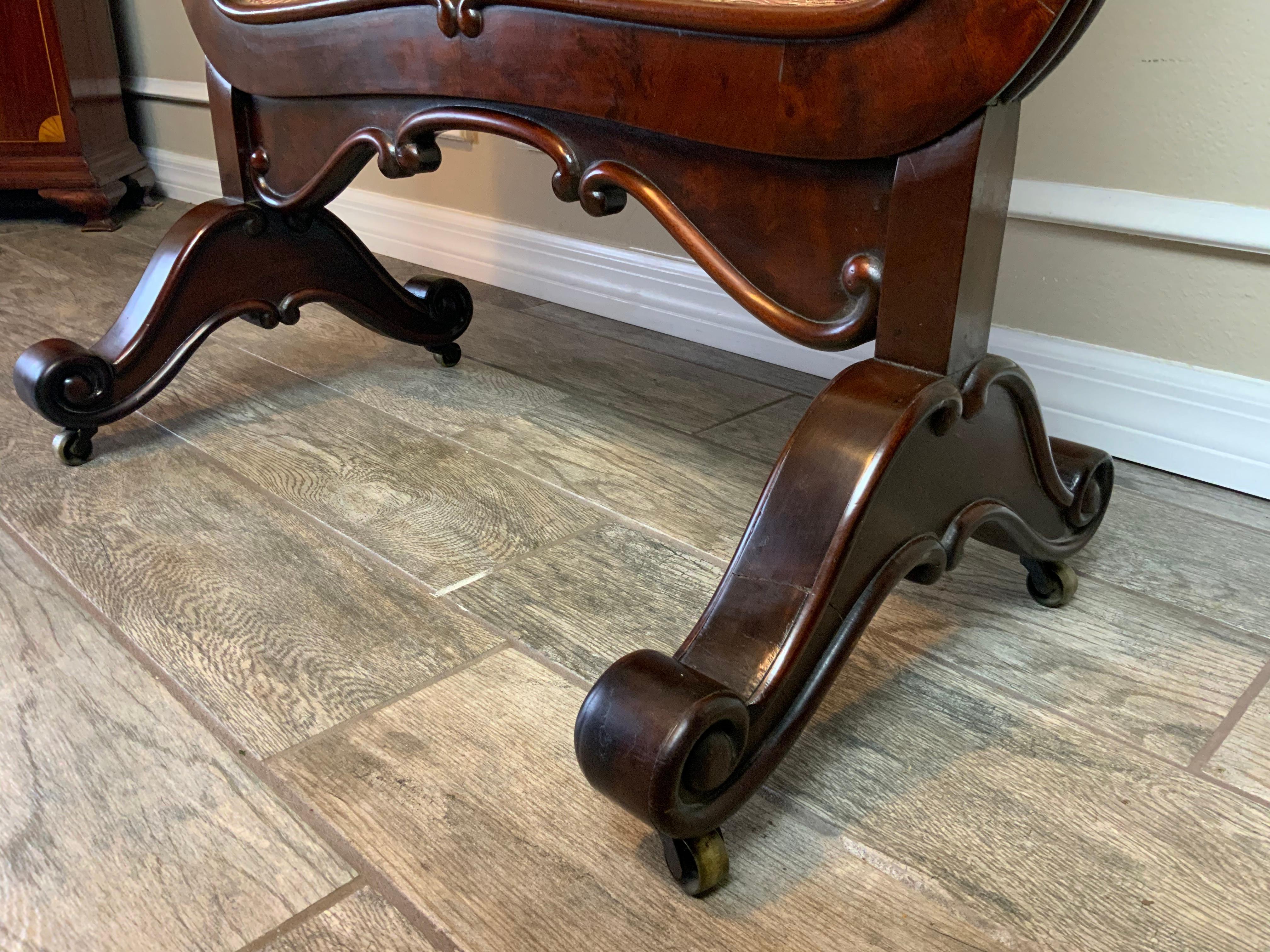 An exceptionally nice large early Victorian era Mahogany fire screen with a beautiful French polish finish.  The original fabric is still intact but is worn in a few areas on each side and the entire panel insert slips out through the space opening