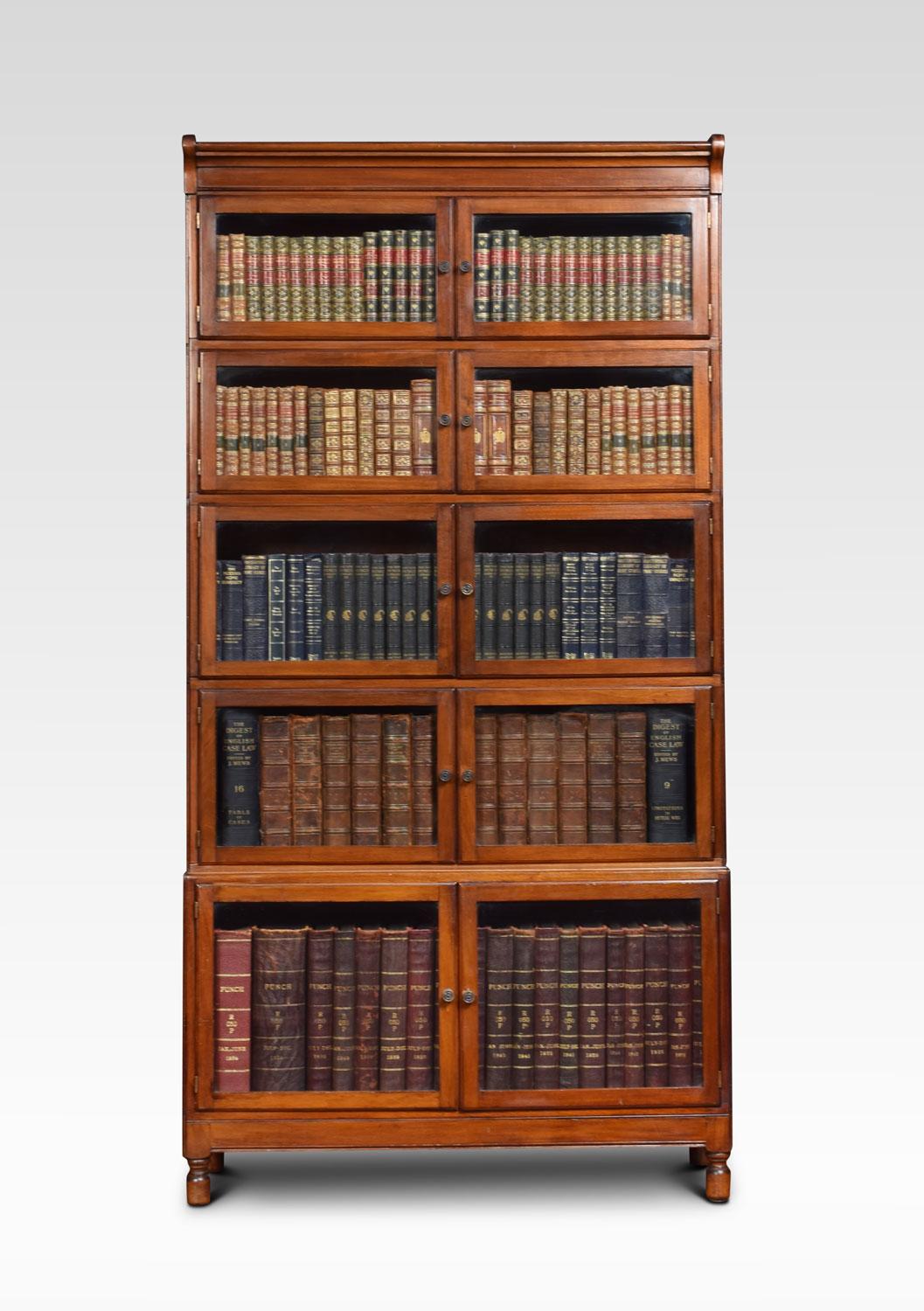 Mahogany five sectional bookcase by Minty Library specialist’s oxford, each with moulded top above five sections with two glazed doors and brass handles. All raised up on four turned legs
Dimensions:
Height 68.5 inches
Length 35 inches
width