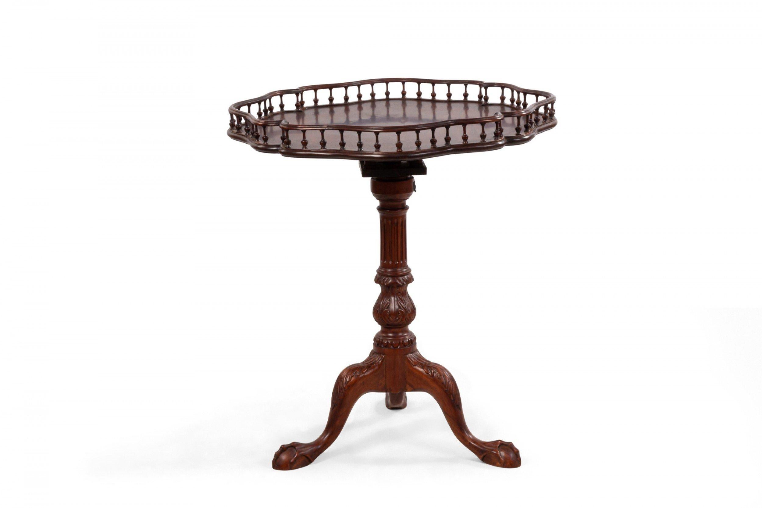 Pair of 20th century English Georgian style similar tilt-top mahogany side/end tables with clover-shaped tops with galleries and pedestal bases (height varies slightly).