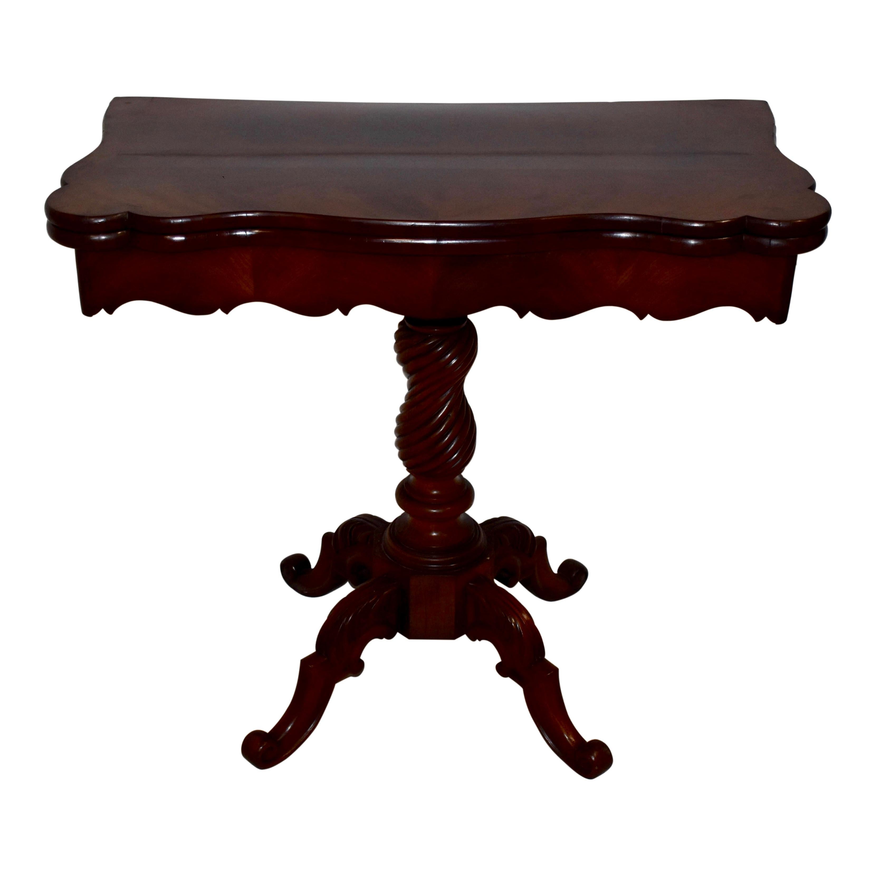 Versatile and functional, this mahogany game table features a hinged top that easily lifts on one side and pivots to open or folds to close. The table offers storage for your favorite games in the scalloped, rectangular base below the top. When