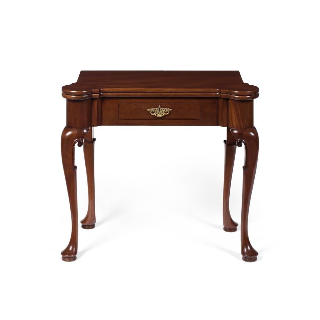 George II style mahogany foldover card table by Gillows of Lancaster, circa 1880. The foldover top with outset rounded corners, opens to a brown baize lined playing surface. It sits above a single frieze drawer with original cast brass handle and a