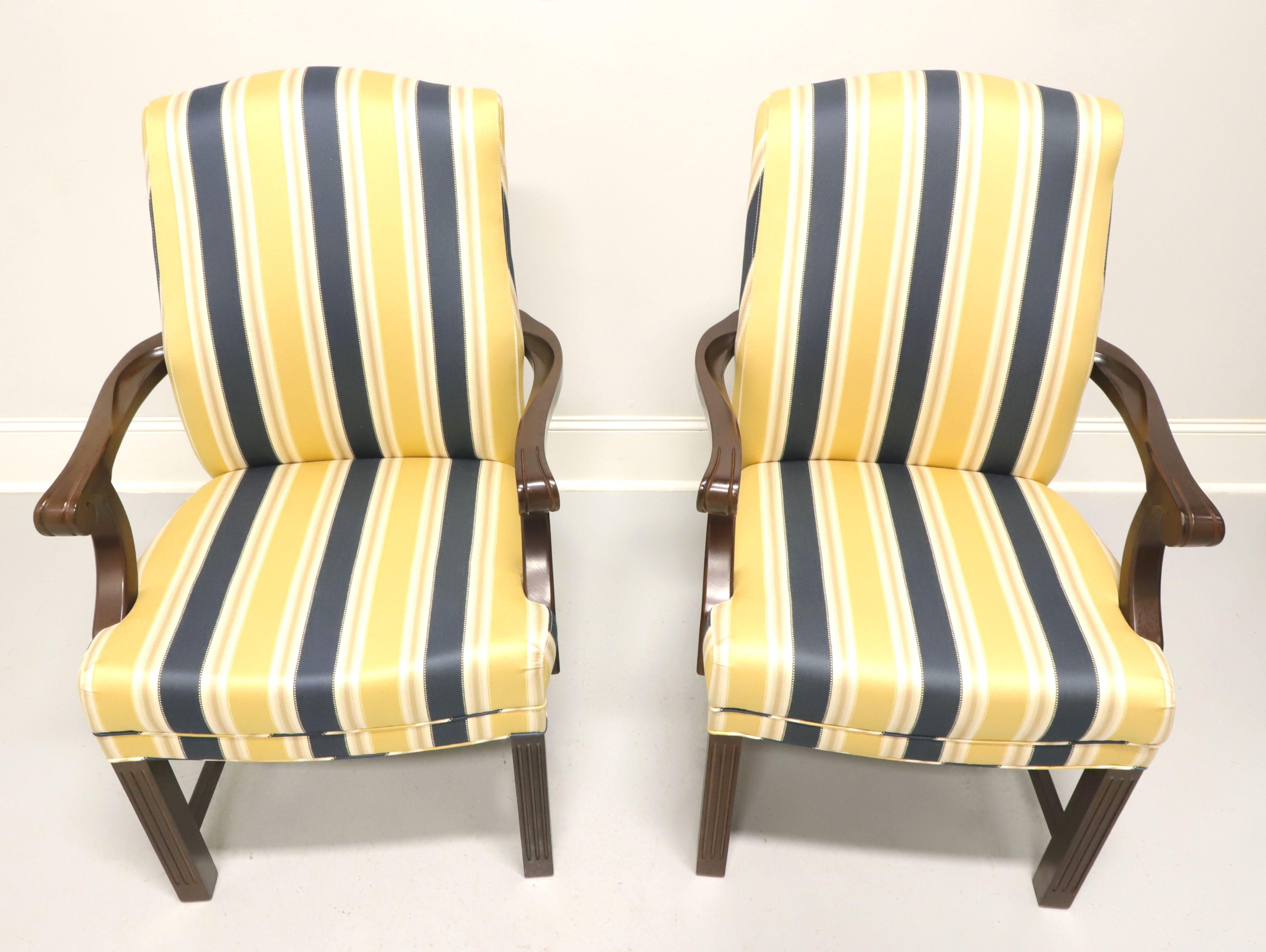 A pair of Chippendale style upholstered armchairs by Patrician Furniture. Navy blue, yellow and white striped fabric upholstery on a mahogany frame with straight legs and stretcher base. Made in High Point, North Carolina, USA, in the late 20th