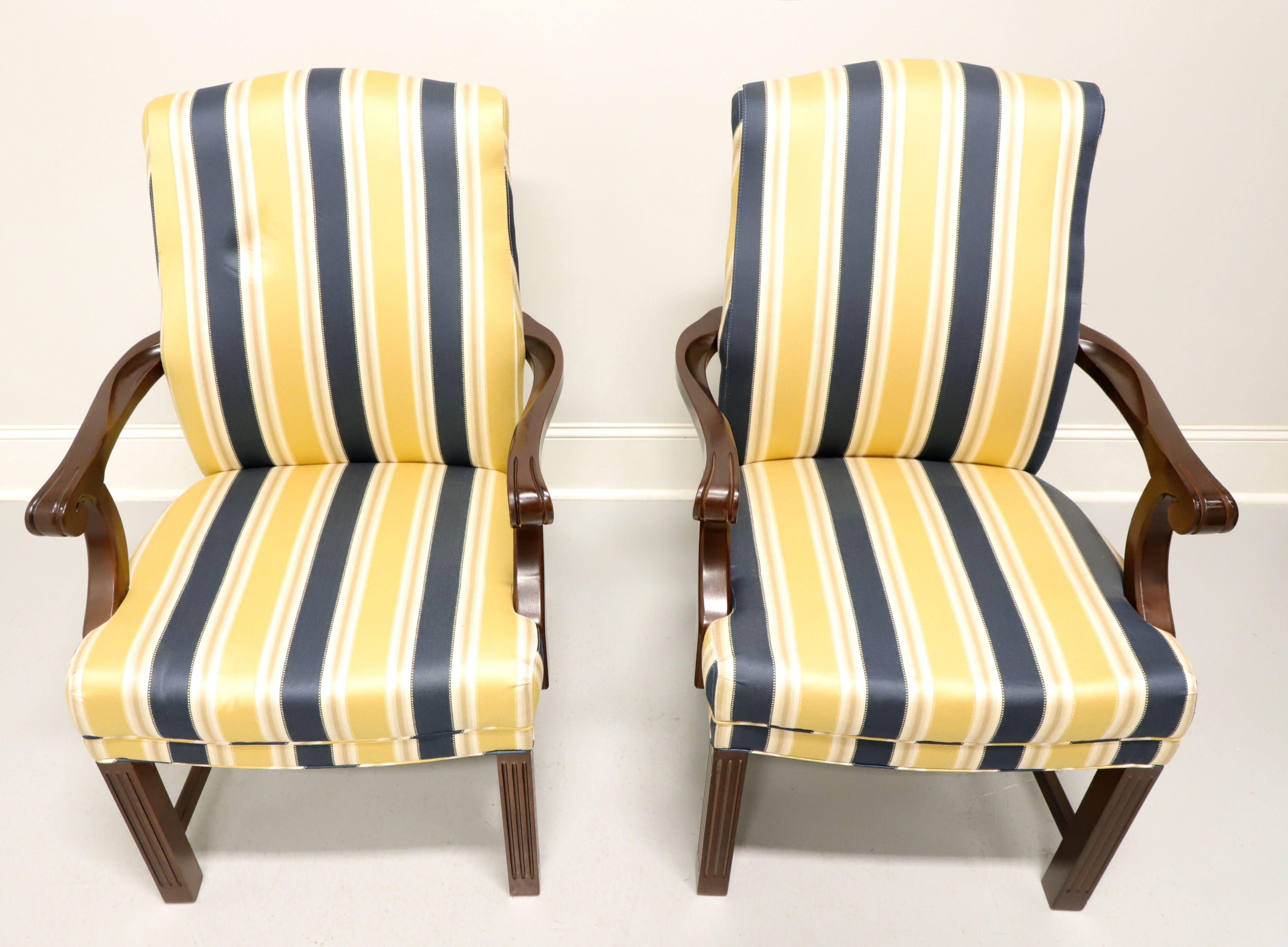 A pair of Chippendale style upholstered armchairs by Patrician Furniture. Navy blue, yellow and white striped fabric upholstery on a mahogany frame with straight legs and stretcher base. Made in High Point, North Carolina, USA, in the late 20th
