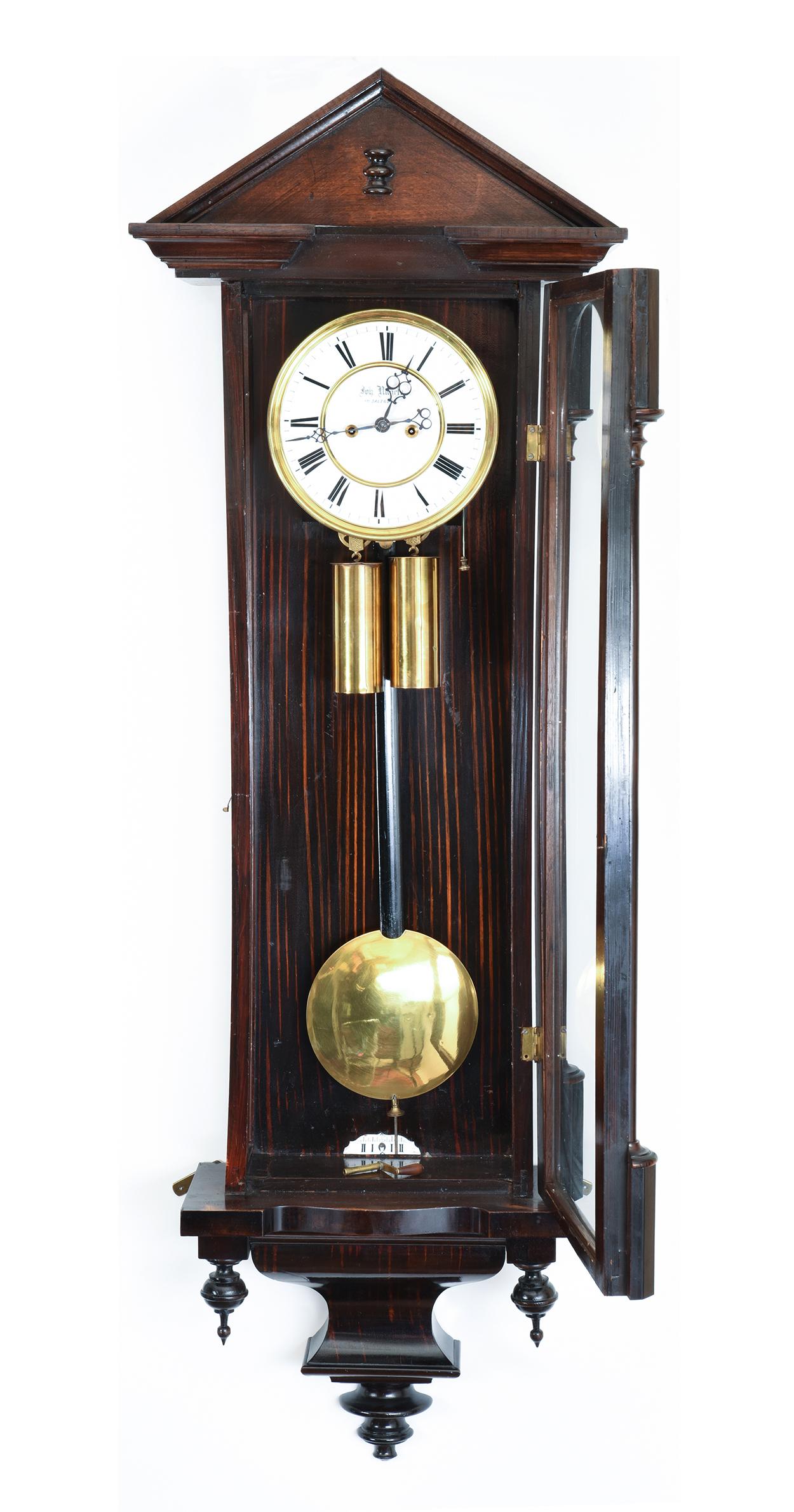 Mahogany frame glass case Vienna regulator clock. Eight day time with porcelain face. The clock is in excellent antique condition. Minor wear consistent with age / use. The clock measure about 44 inches high x 1 2 inches width x 5.5 inches deep.