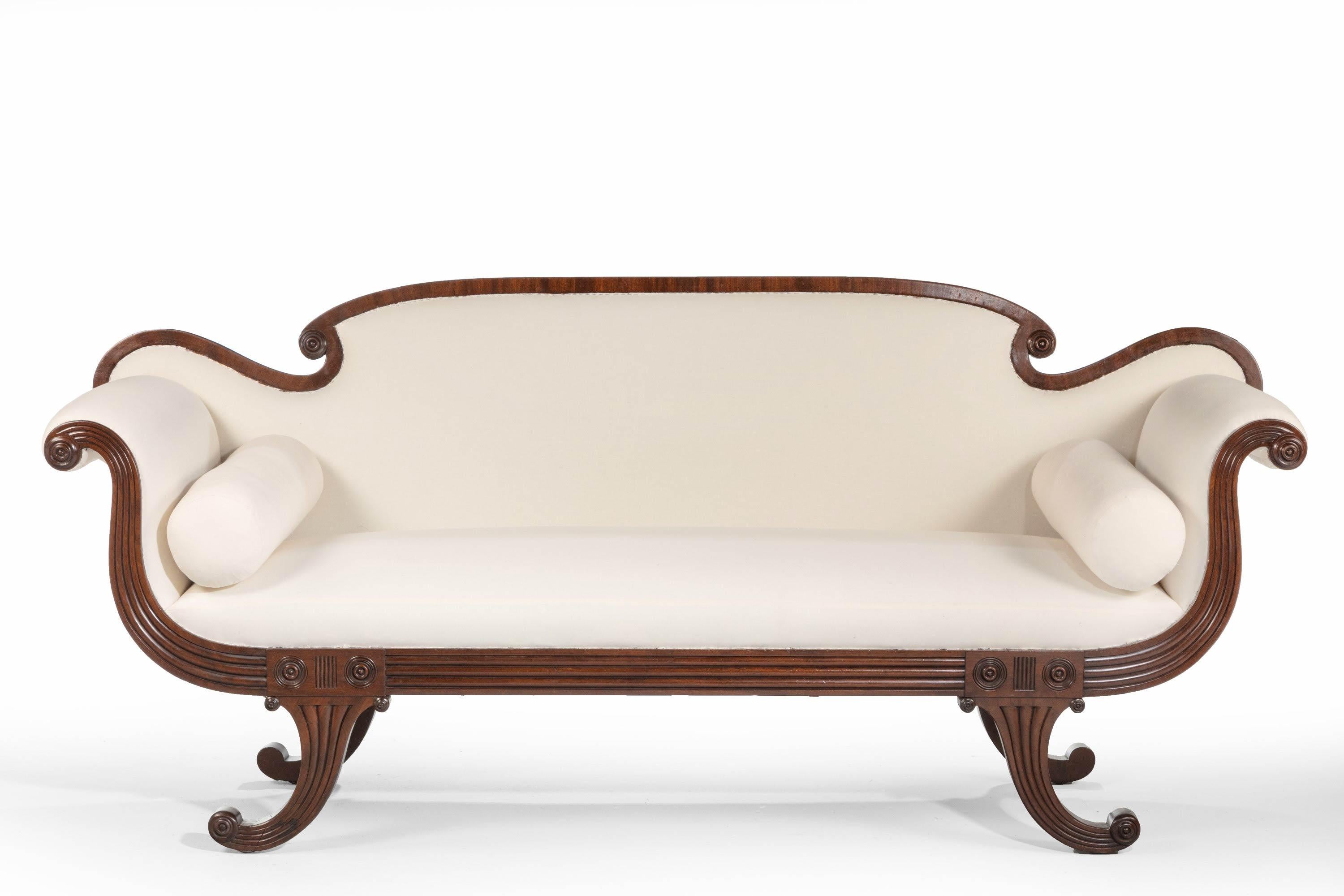 A mahogany framed Regency period sofa. With a most attractive continuous border on strong sabre legs. Excellent overall shape and condition. Newly upholstered to white. 

Seat height: 21 inches.
 