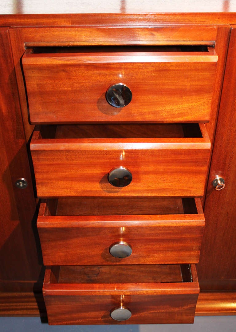 Refined mahogany French Art Deco sideboard. Elegant proportions with a set of four drawers on the center range. Two shelves in both side cases. Nickel-plated handles.
Very good condition for age, carefully refinished.
Handles has been changed for