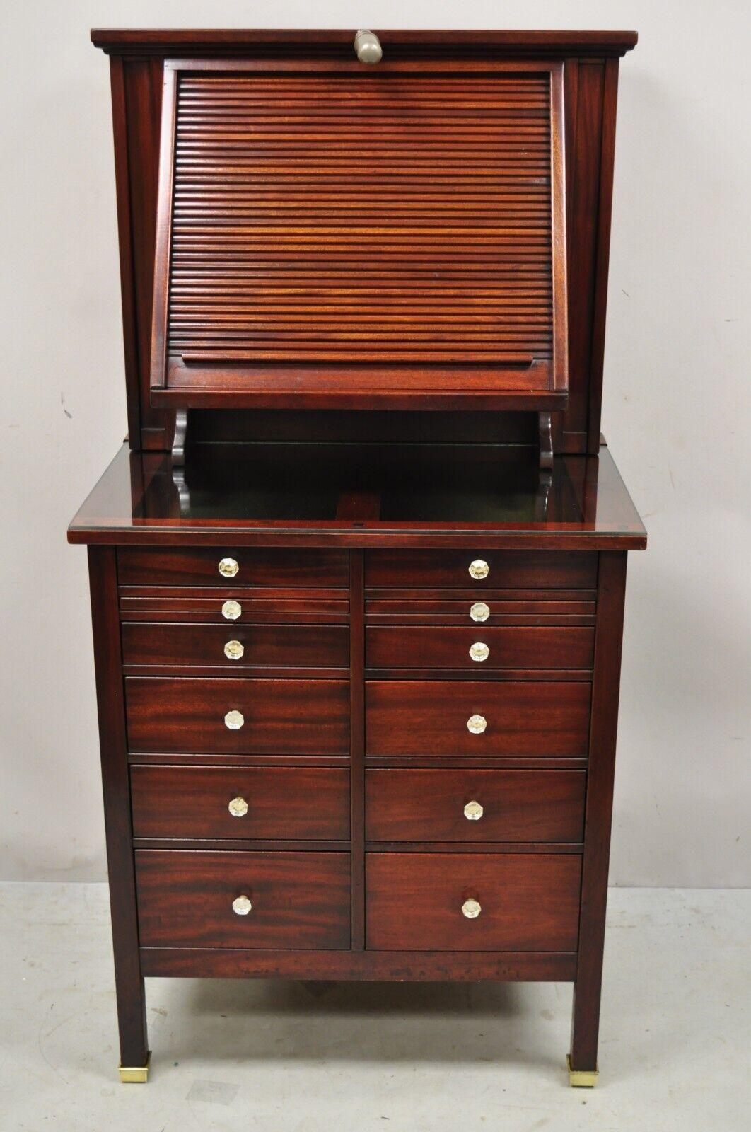Antique Mahogany Genothalmic Cabinet by General Optical Co. Roll Top Medical Work Desk Station. Item features brass capped feet, glass display surface, green felt lined top drawers, single work/task light, roll top with storage interior, panel back,