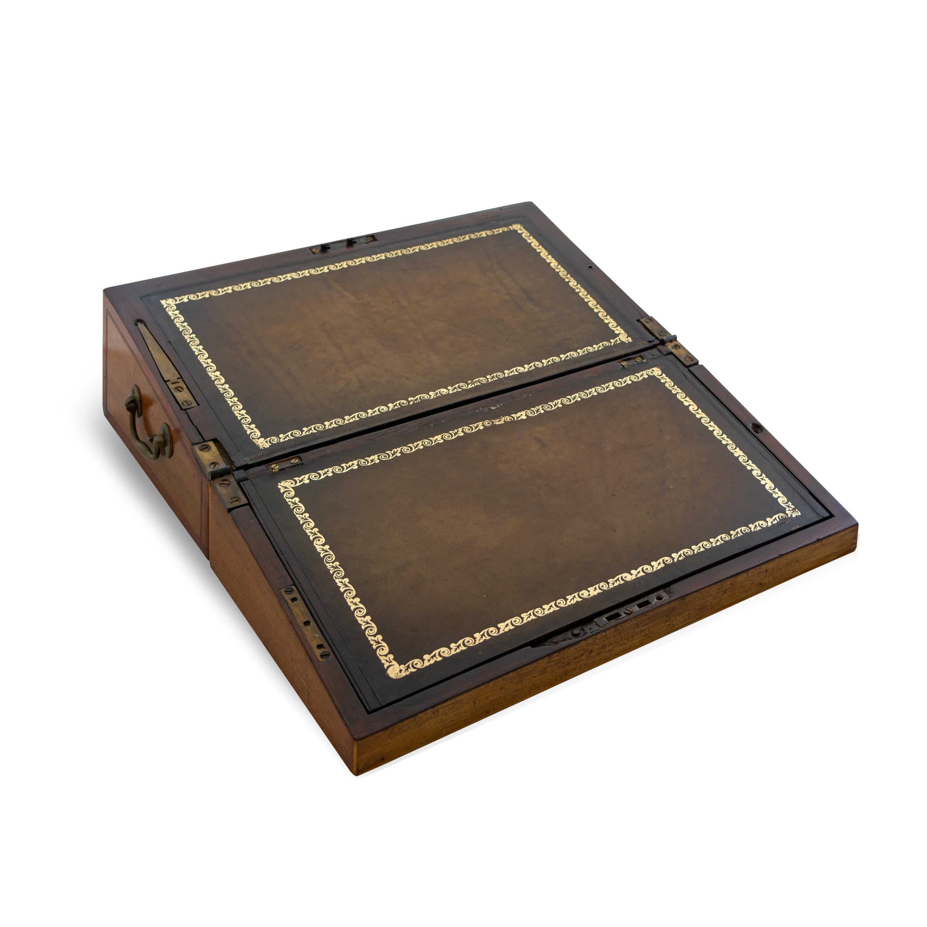 This is a classic George III lap desk with circular satinwood inlay on lid and mahogany banding. The box is situated on a later custom stand with chamfered legs, Circa 1800.