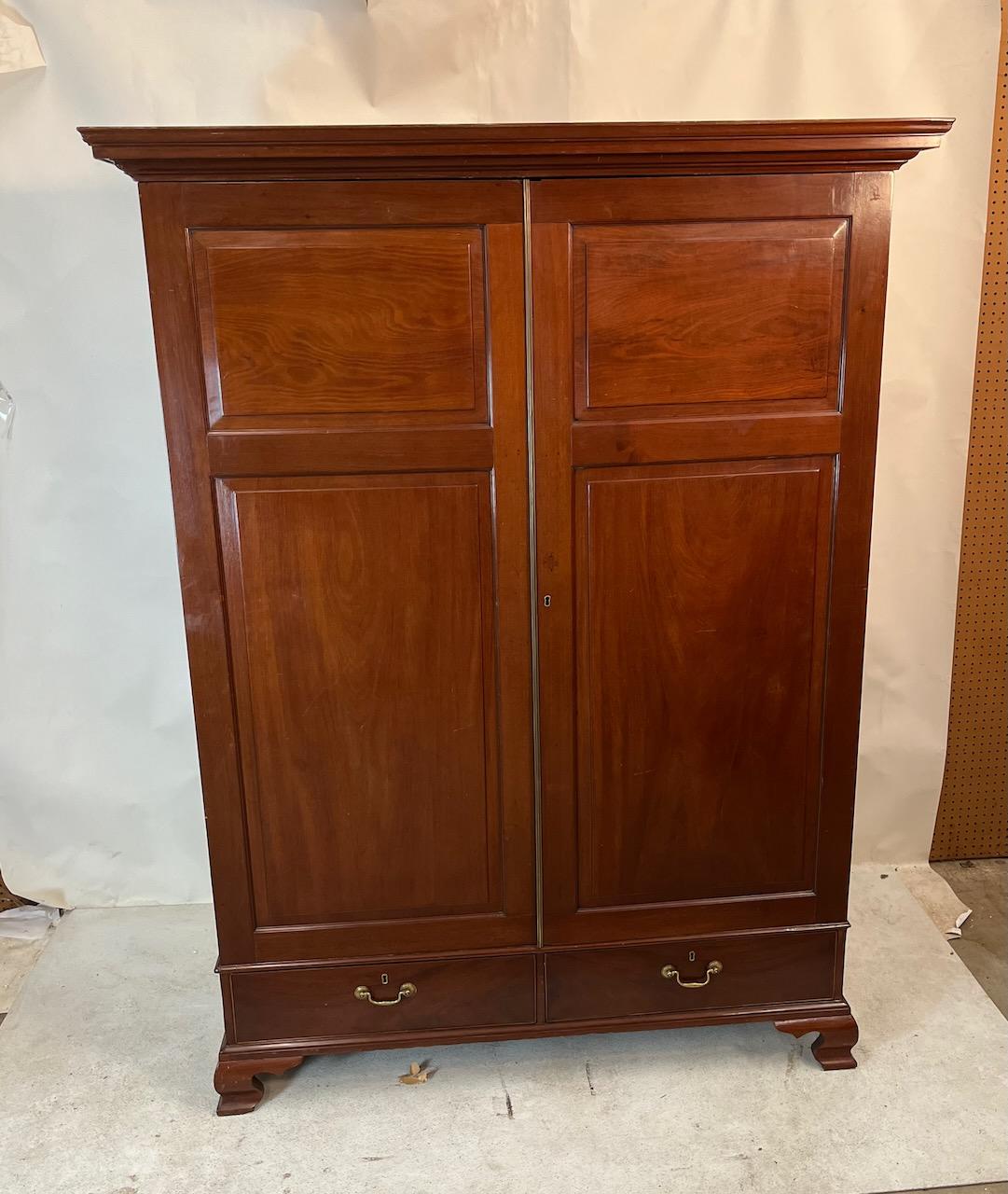 Mahogany Georgian two door wardrobe with bottom drawer. Slight scratches on rear of left side panel. Original swan hardware and hooks.  Mahogany and pine.