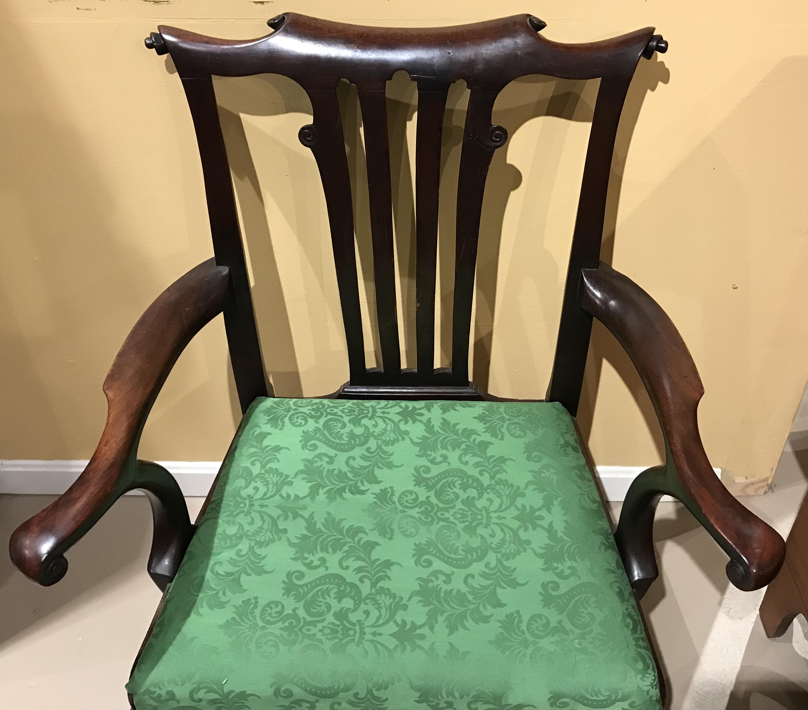 A fine example of an English Georgian mahogany side chair with scroll carved crest, arms, and splat, supported with front cabriole legs with turned stretchers. Roman numeral VII carved in the base of the back splat. In very good condition, with