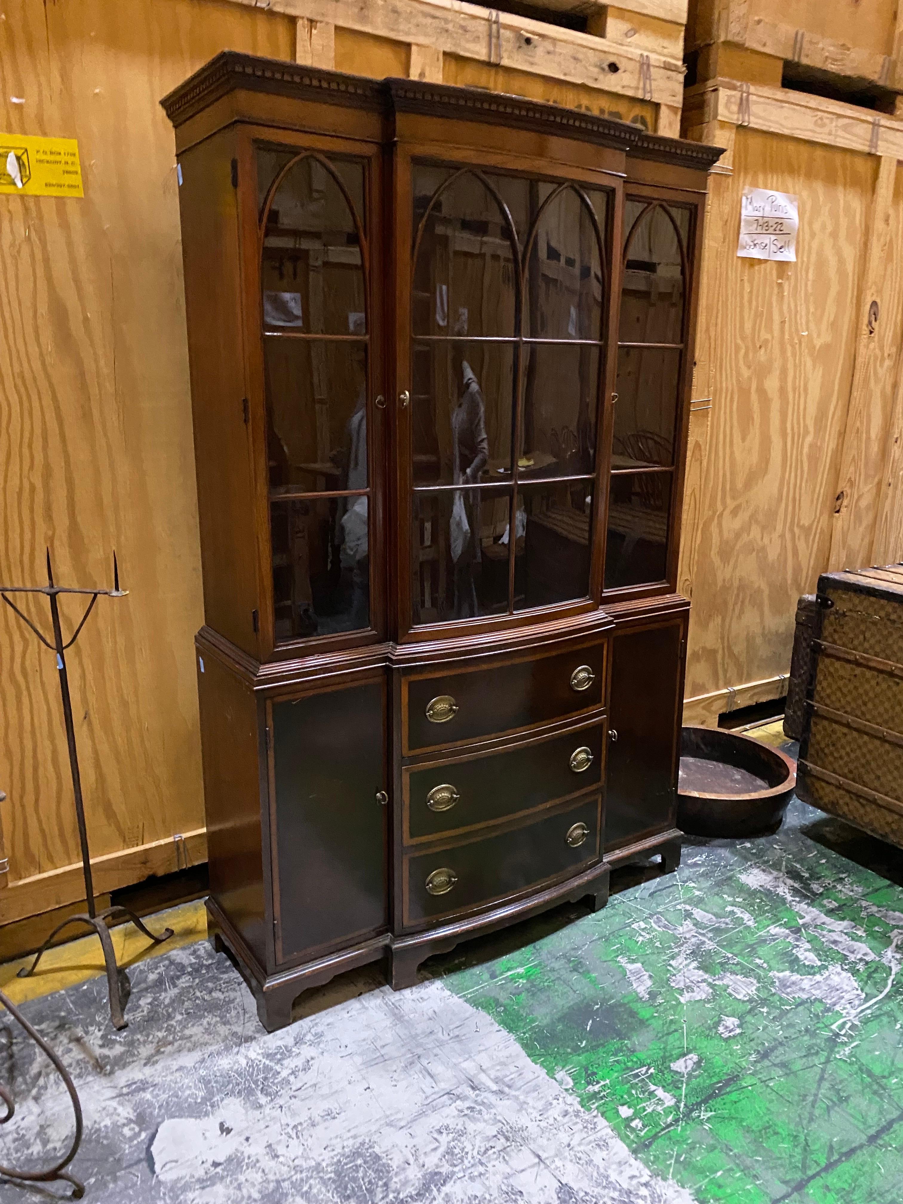Mahogany Georgian style bowfront bookcase by Fancher Furniture Co.
A lovely 20th Century reproduction with bowfront central glass door on the upper section and flat glass doors on either side and adjustable shelves. Bottom section, three central