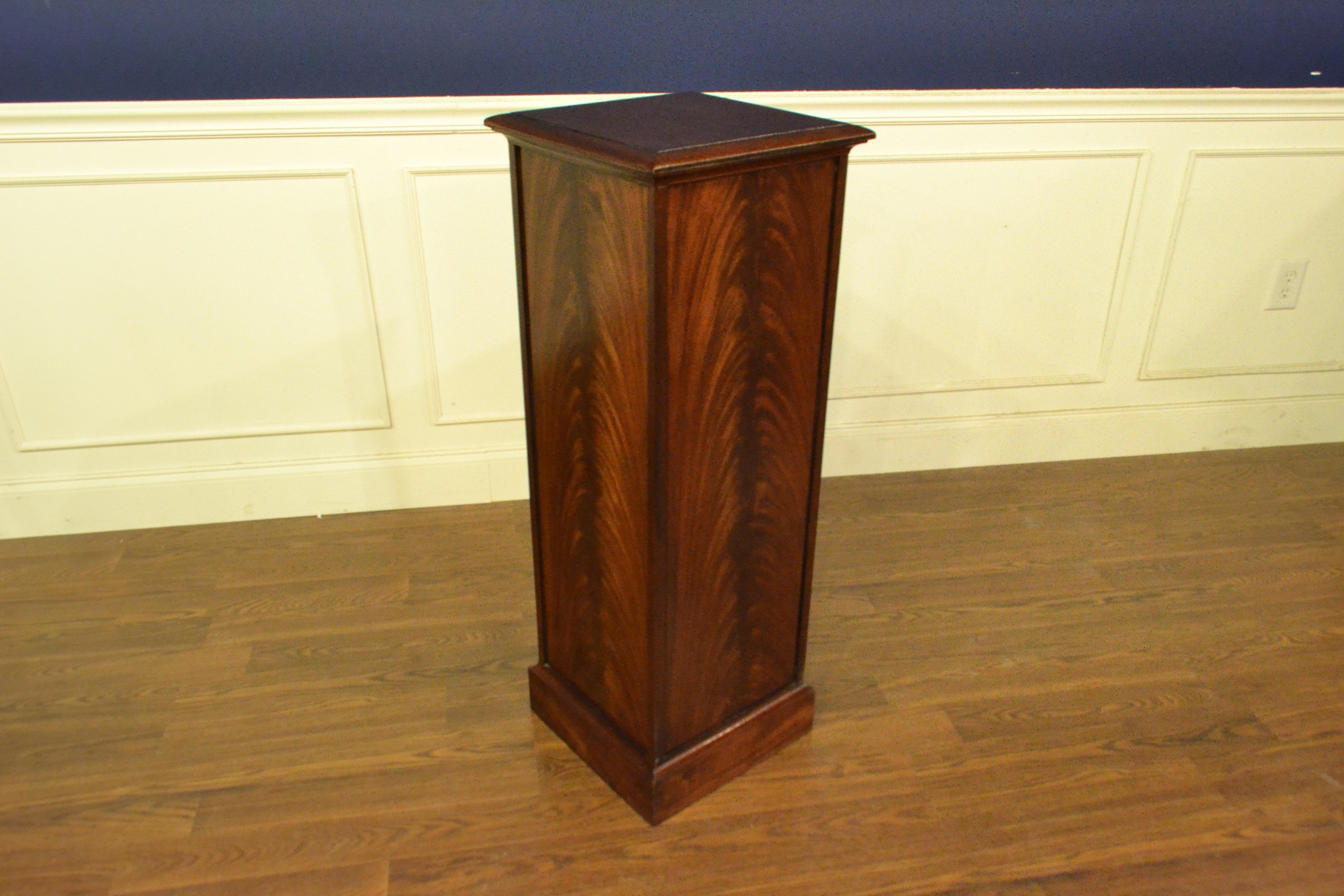 This is made-to-order traditional mahogany display pedestal made in the Leighton Hall shop. It’s four sides feature swirly crotch mahogany fields and the top is cathedral mahogany with a traditional ogee profiled edge. It is finished in a satin