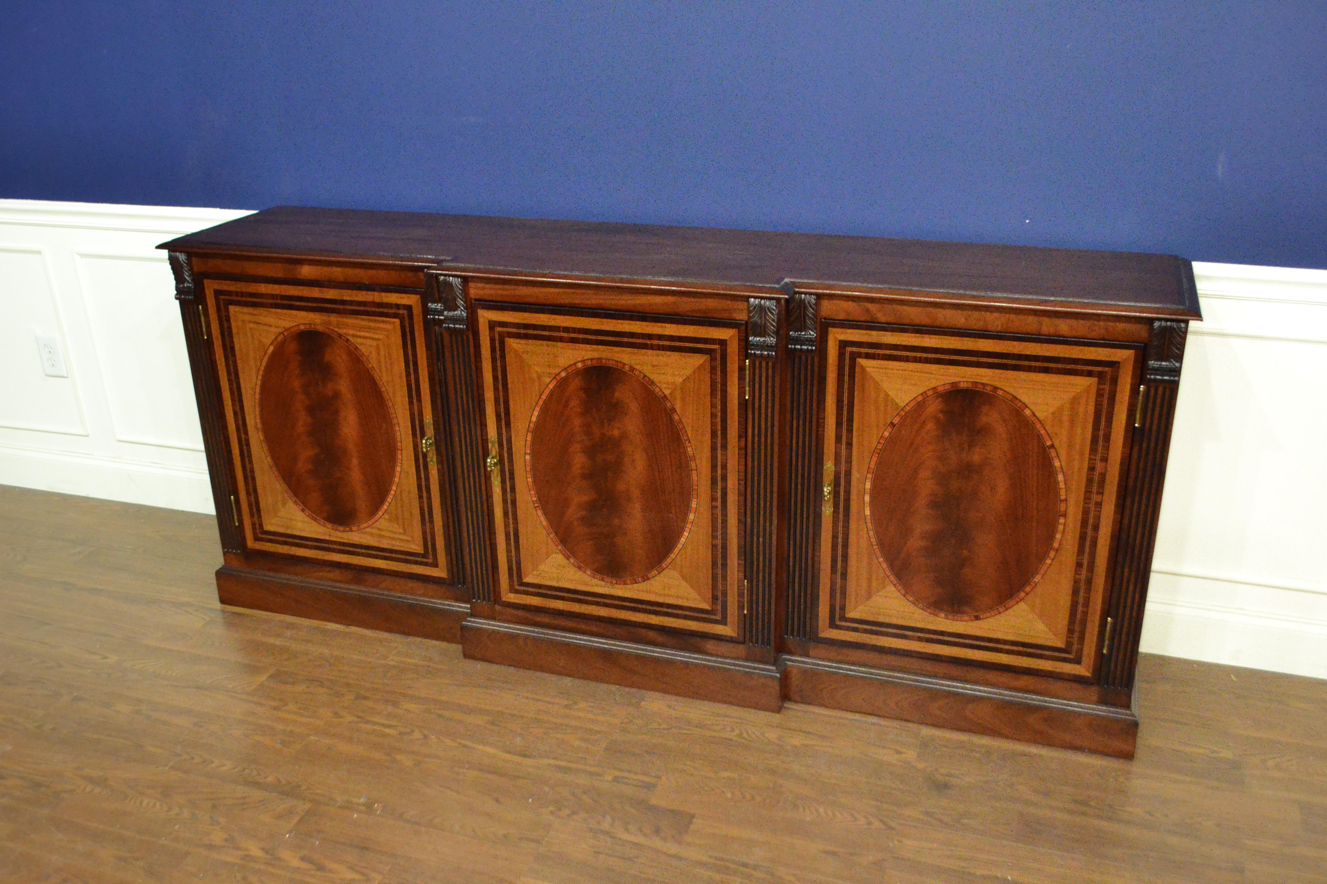 This is made-to-order traditional mahogany three door buffet or credenza made in the Leighton Hall shop. It features three doors with swirly crotch mahogany fields and satinwood and santos rosewood borders. It has a cathedral mahogany top with a