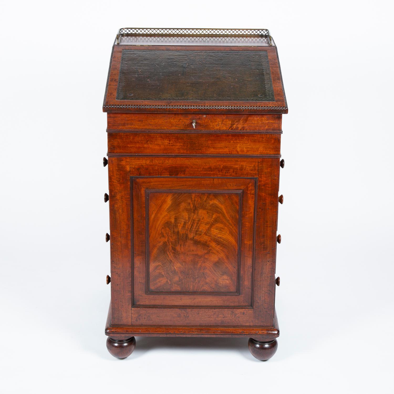 A Regency period mahogany Davenport firmly attributed to Gillows of Lancaster, with a forward sliding bureau section with tooled leather writing surface and a gilt brass pierced gallery, the interior of the bureau has two real and two dummy small