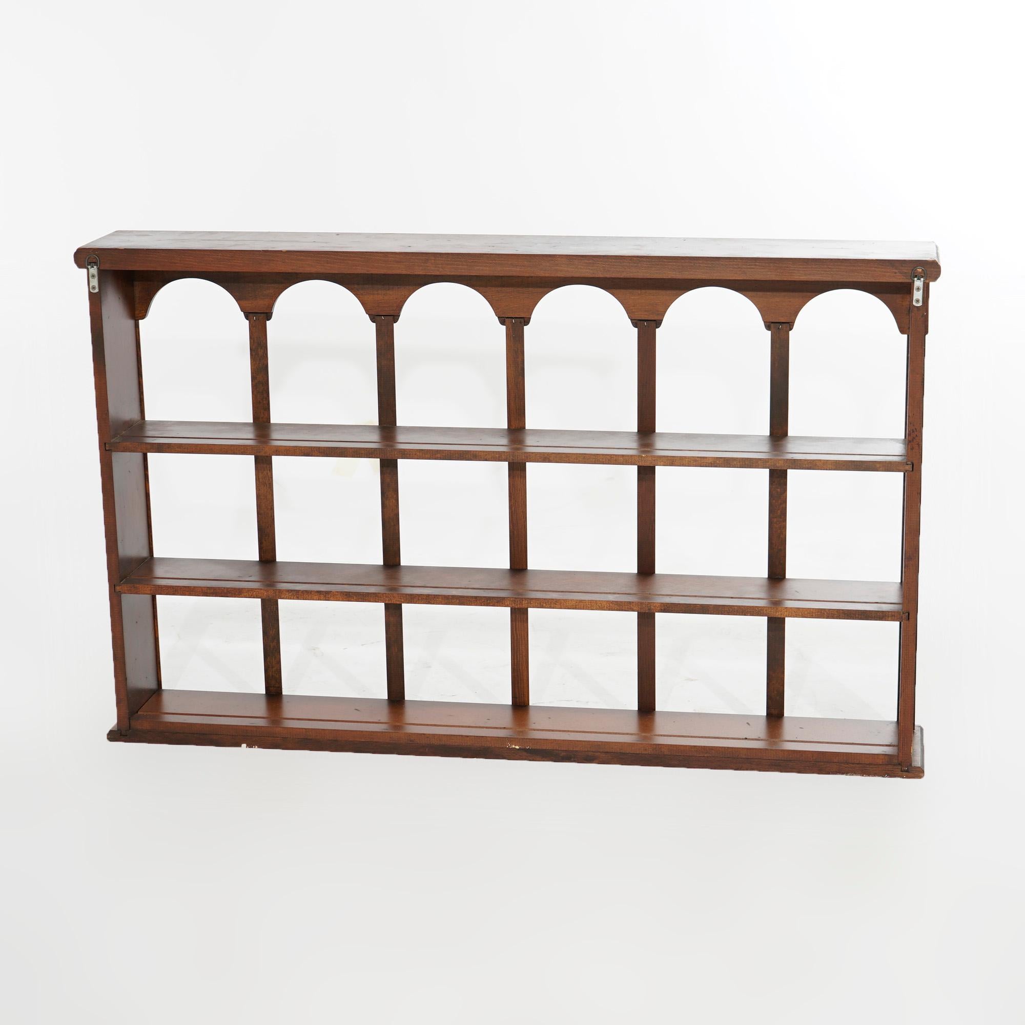 A hanging curio display wall shelf offers mahogany construction with three shelves and arched upper compartments, 20th century

Measures- 24.5''H x 39.5''W x 6''D.

Catalogue Note: Ask about DISCOUNTED DELIVERY RATES available to most regions within