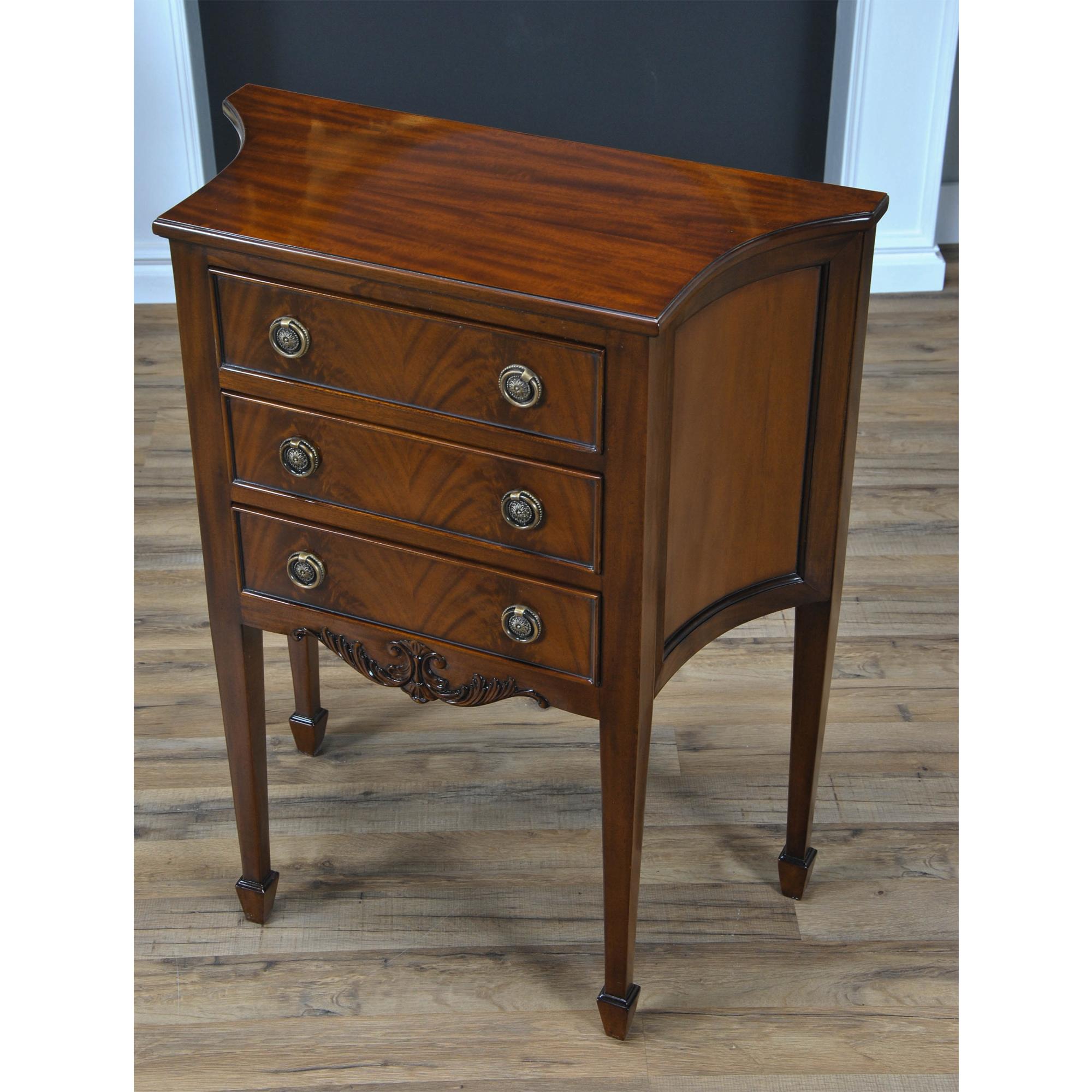 This Mahogany Hepplewhite Commode is great for use as a side table or entry way piece. The three drawers are dovetailed and feature designer style hardware, curved and shaped sides lend elegance and style to any room. Hand carved details in the