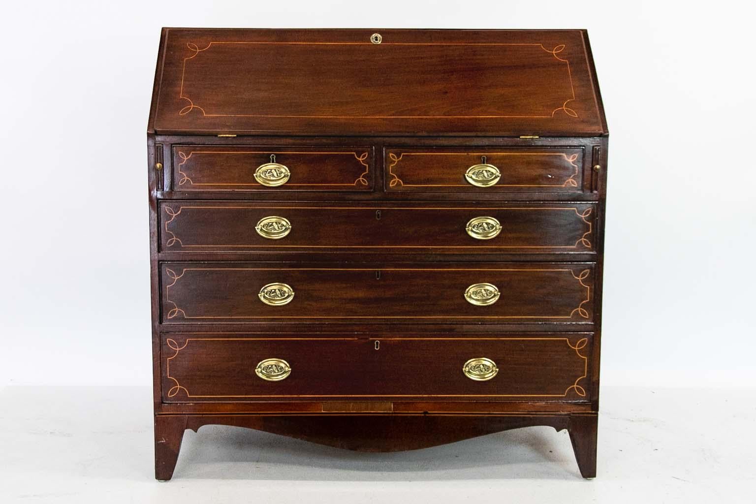 Mahogany Hepplewhite inlaid slant front desk, is inlaid with boxwood and has lovely nautical brass handles, interior with leather writing surface, multiple drawers and prospect door inlaid with oval medallion.
 