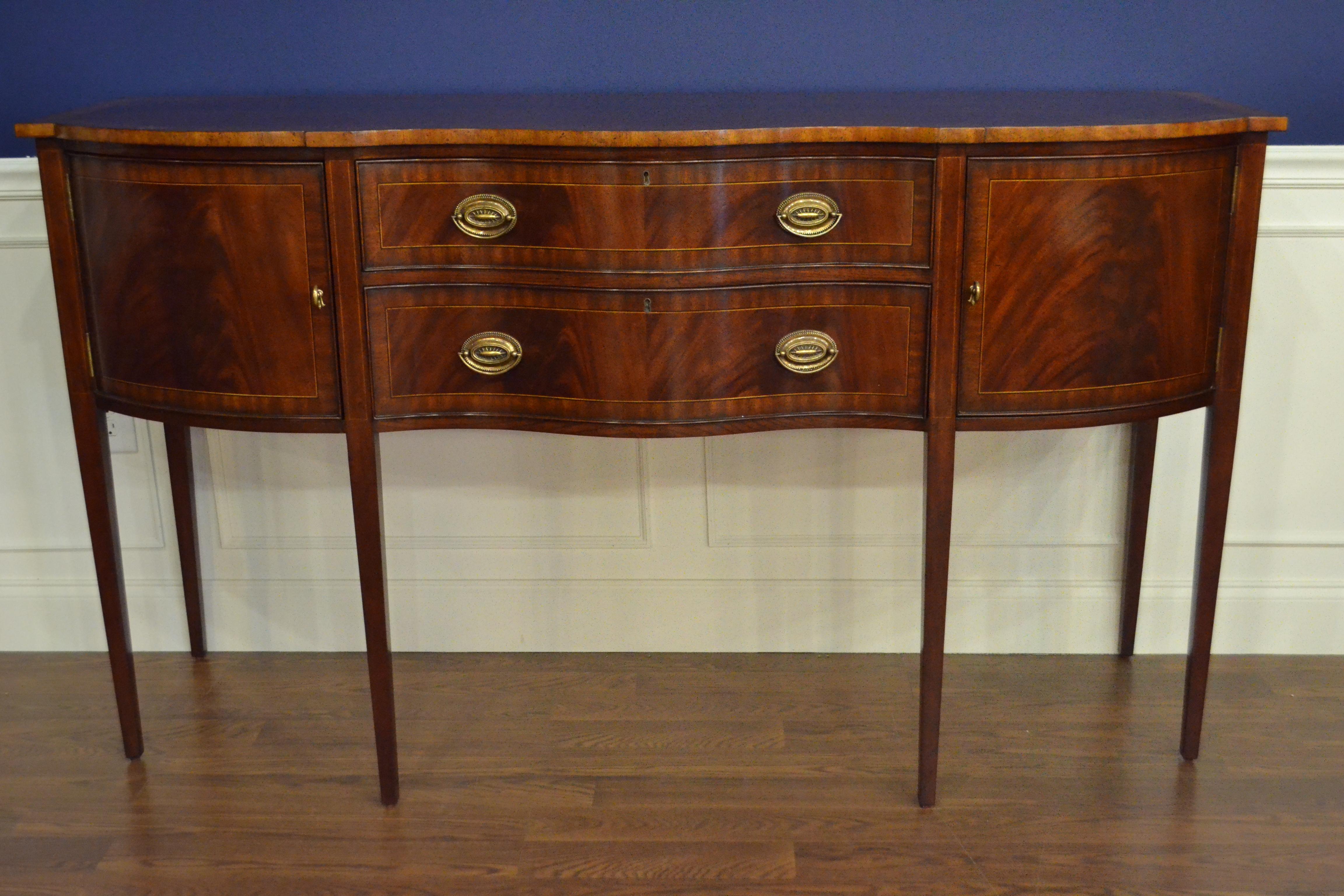 This is a new traditional mahogany sideboard. It’s design was inspired by the Hepplewhite sideboards from the Regency period and features a Classic serpentine shaped front. It features doors, drawers and a top with swirly crotch mahogany fields and