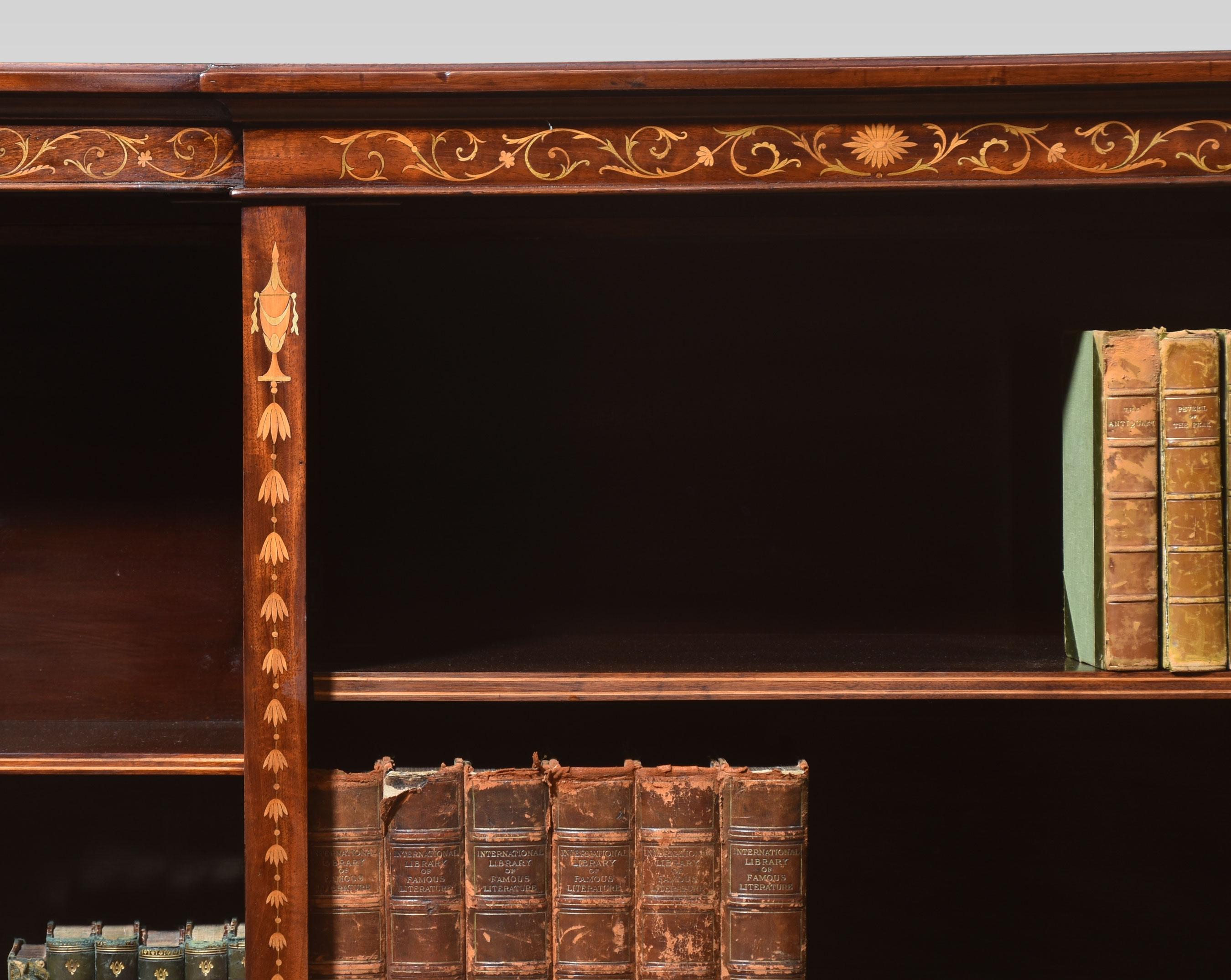Mahogany breakfront bookcase in the manner of Edwards and Roberts, having rectangular-shaped top and moulded edge. To the freeze with floral swags and ribbons. Above three bays of adjustable shelves. All raised up on a plinth base.
Dimensions
Height