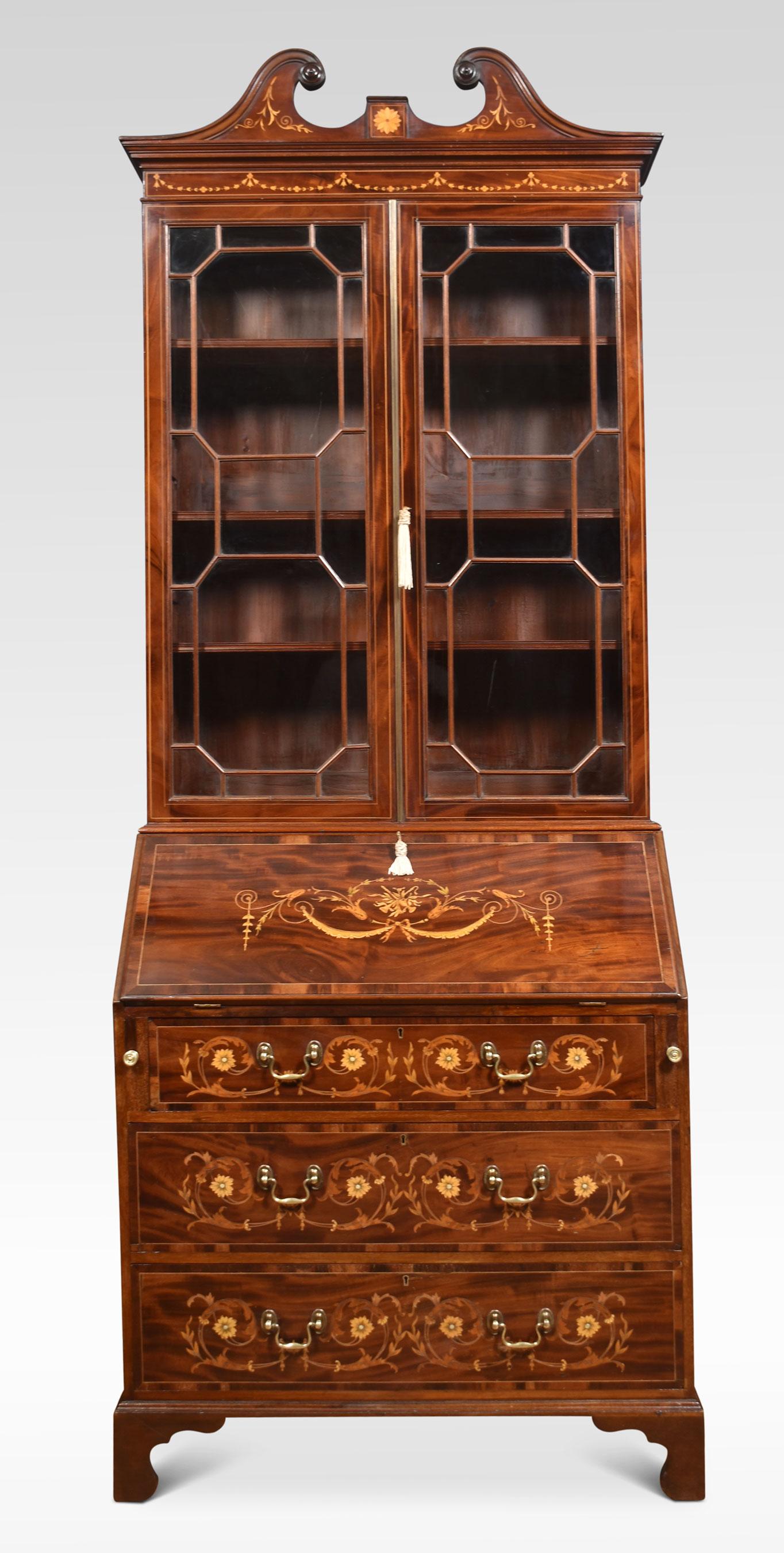 Mahogany bureau bookcase, the raised swan neck inlaid pediment above a pair of glazed doors opening to reveal adjustable shelved interior. To the fall front, profusely inlaid with flowers and swags opening to reveal a fully fitted interior and