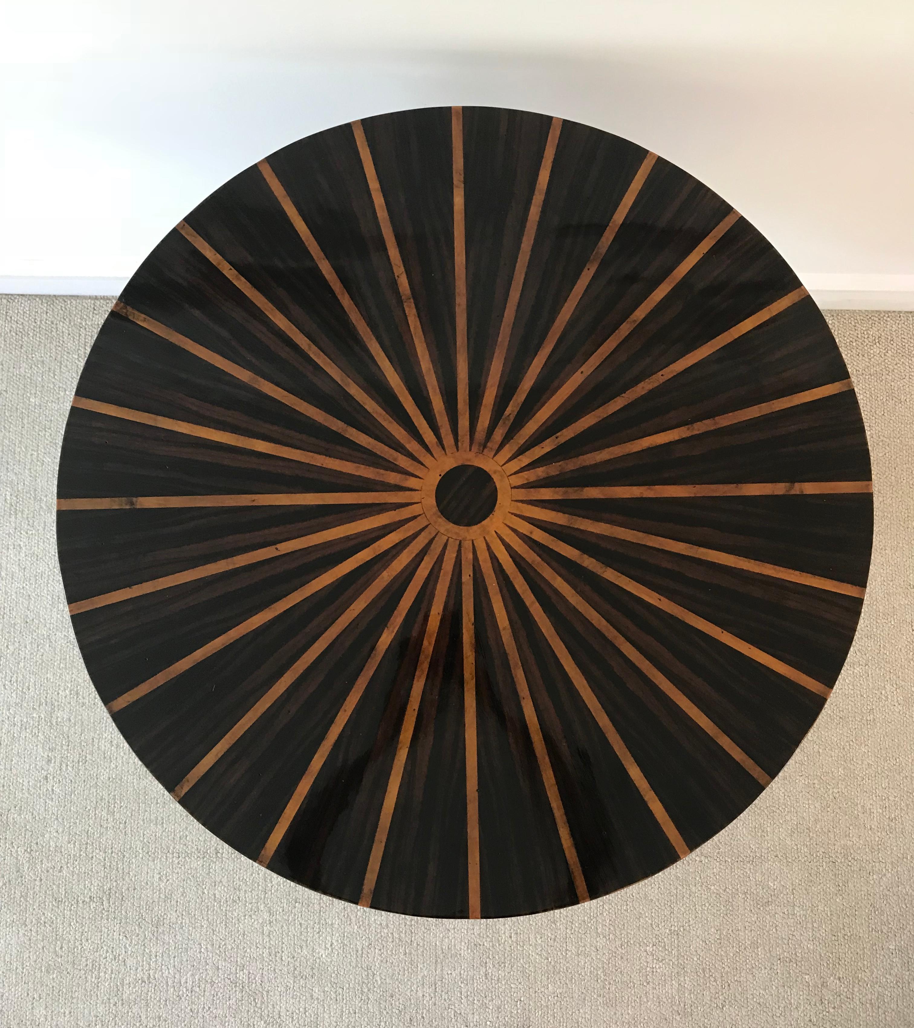 Stunning sunburst pattern on this versatile inlaid table with gold bands on the center base. The size is ideal for a corner table or a small and stunning statement in an entry/foyer. Can also be used with two armchairs for a special conversation