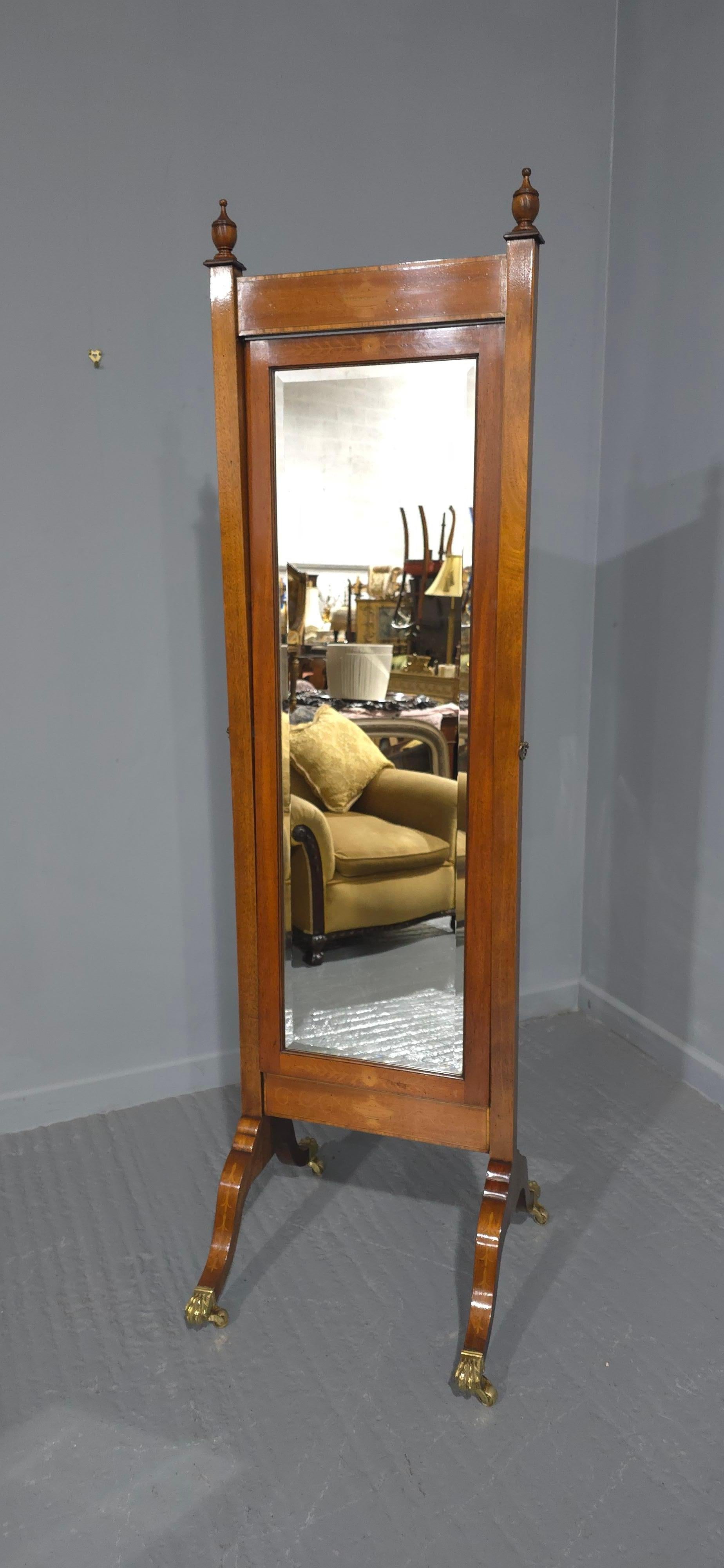 Good mahogany cheval mirror with inlaid top and bottom, inlaid legs, brass castors, original mrror, in excelent overall condition.

78