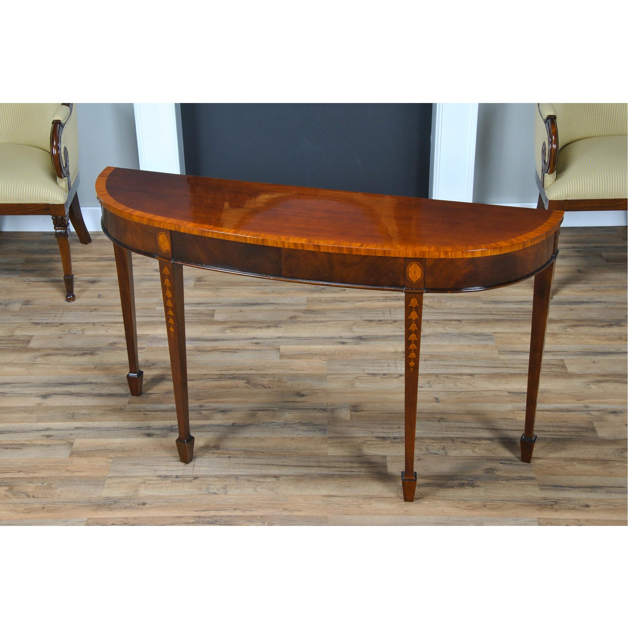 Designed after an English antique, this high quality Mahogany Inlaid Console makes elaborate use of high quality inlays. Drawing inspiration in design from the famous English Cabinet maker George Hepplewhite the console is narrow enough to be used