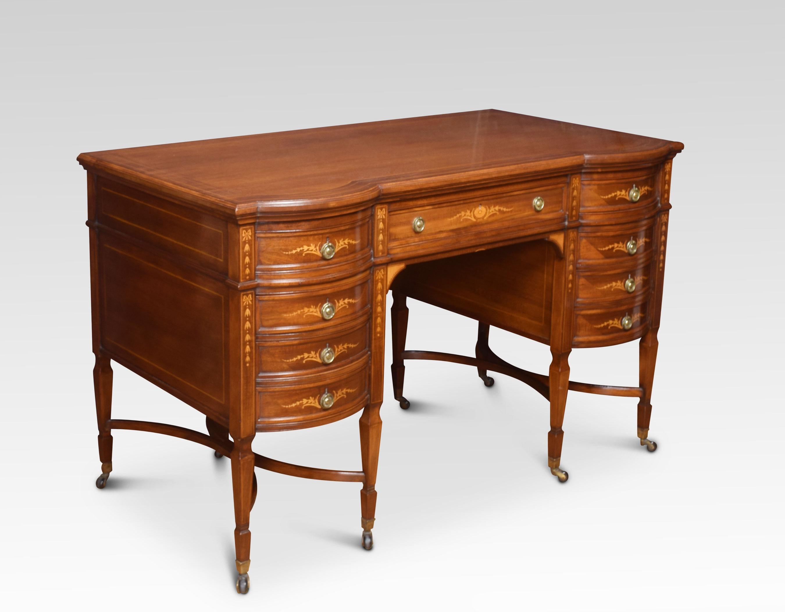 Mahogany inlaid dressing table the large rectangular top with line inlaid detail. Above central inlaid draw with floral swags and ribbons flanked by two banks of drawers to either side with similar inlay and tooled brass ring handles. All raised up
