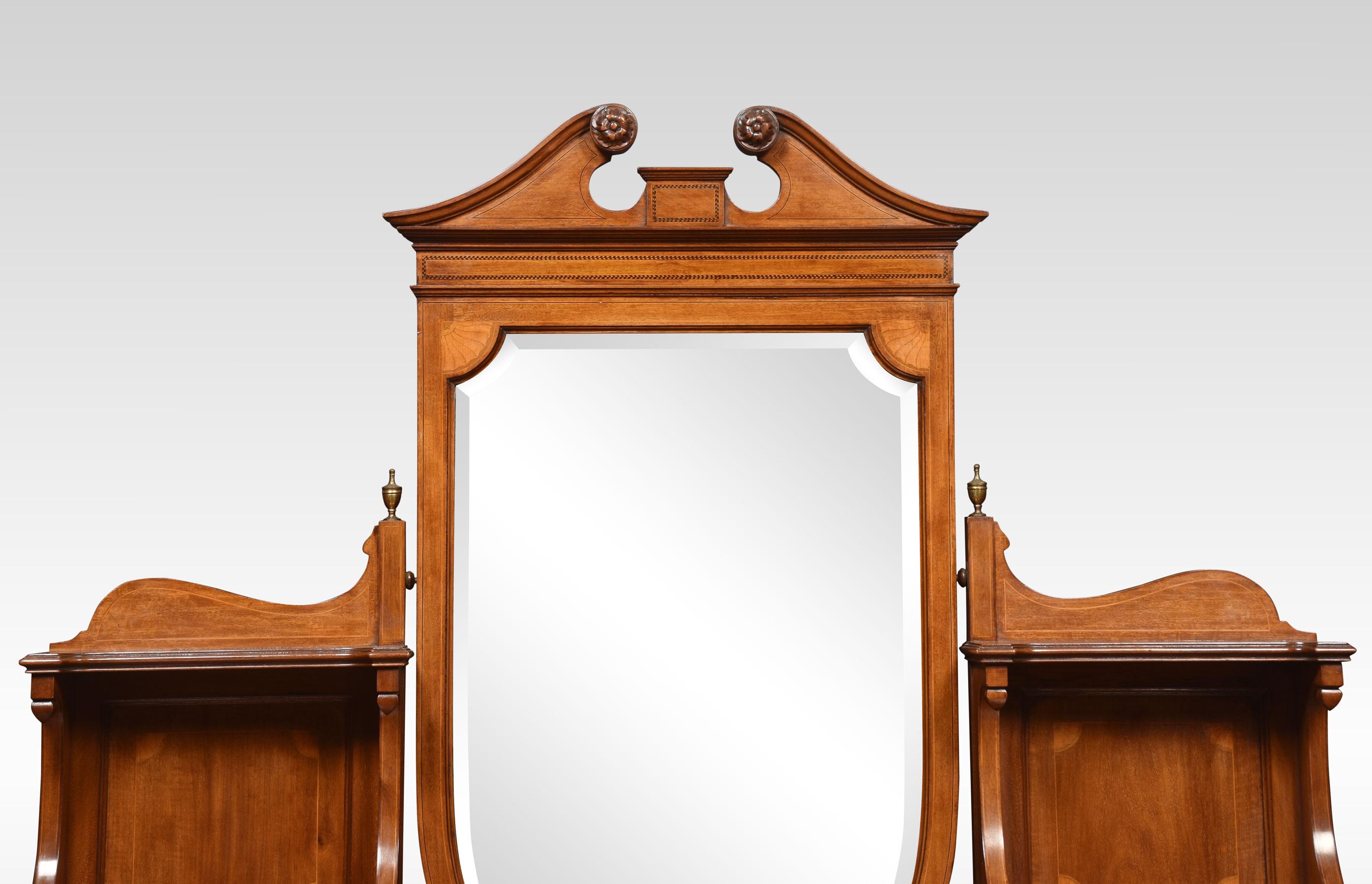 Mahogany dressing table, the Shield Shaped bevelled mirror flanked by a superstructure with short drawers below to the figured mahogany stepped top enclosed by a moulded edge. The base section is fitted with an arrangement of drawers all having