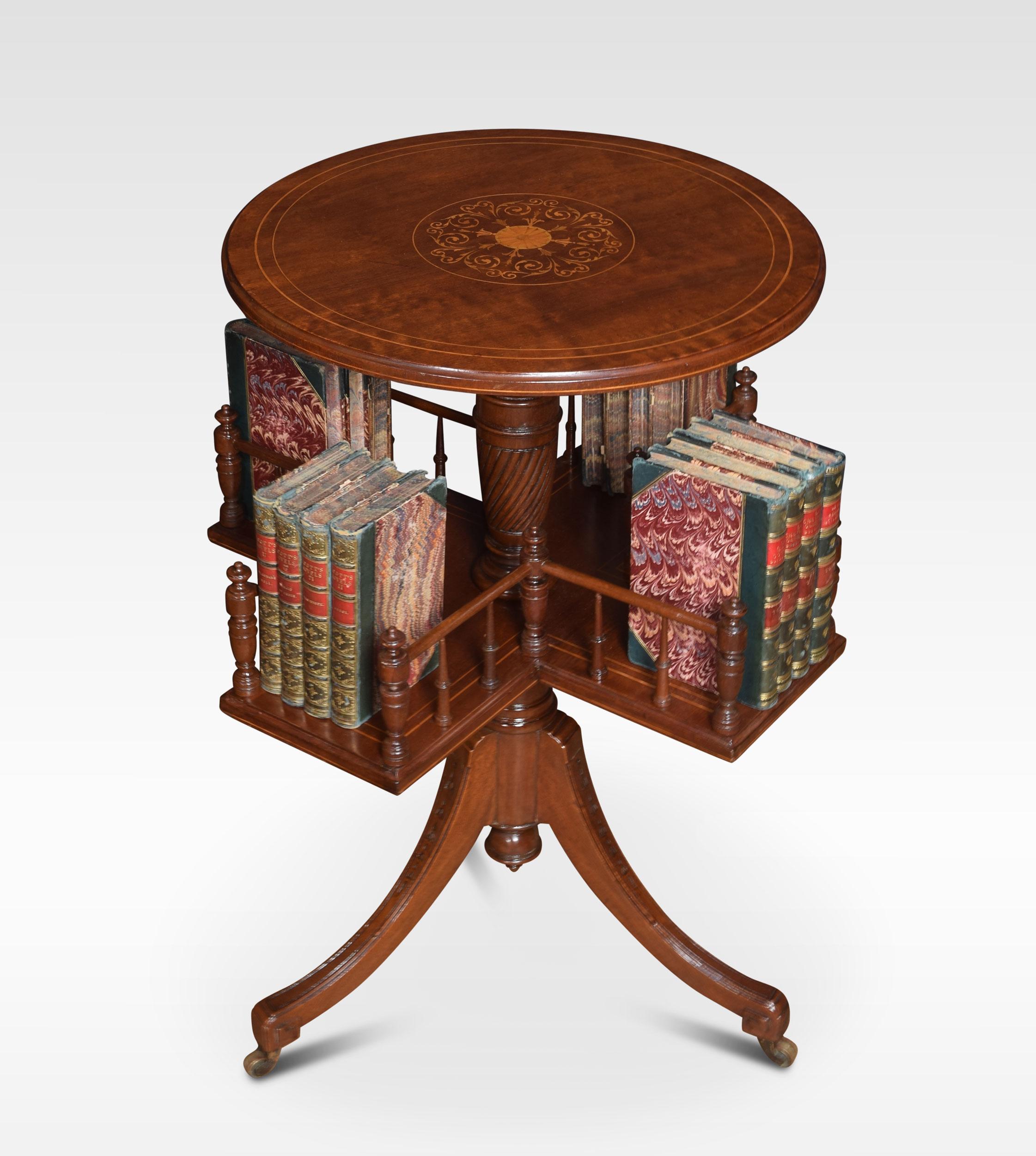 Regency style mahogany inlaid revolving book table the circular top with inlaid decoration. Raised up on spiral fluted support with revolving three-division bookshelf under tier All raised up on tripod base.
Dimensions
Height 28.5 inches
Width 21