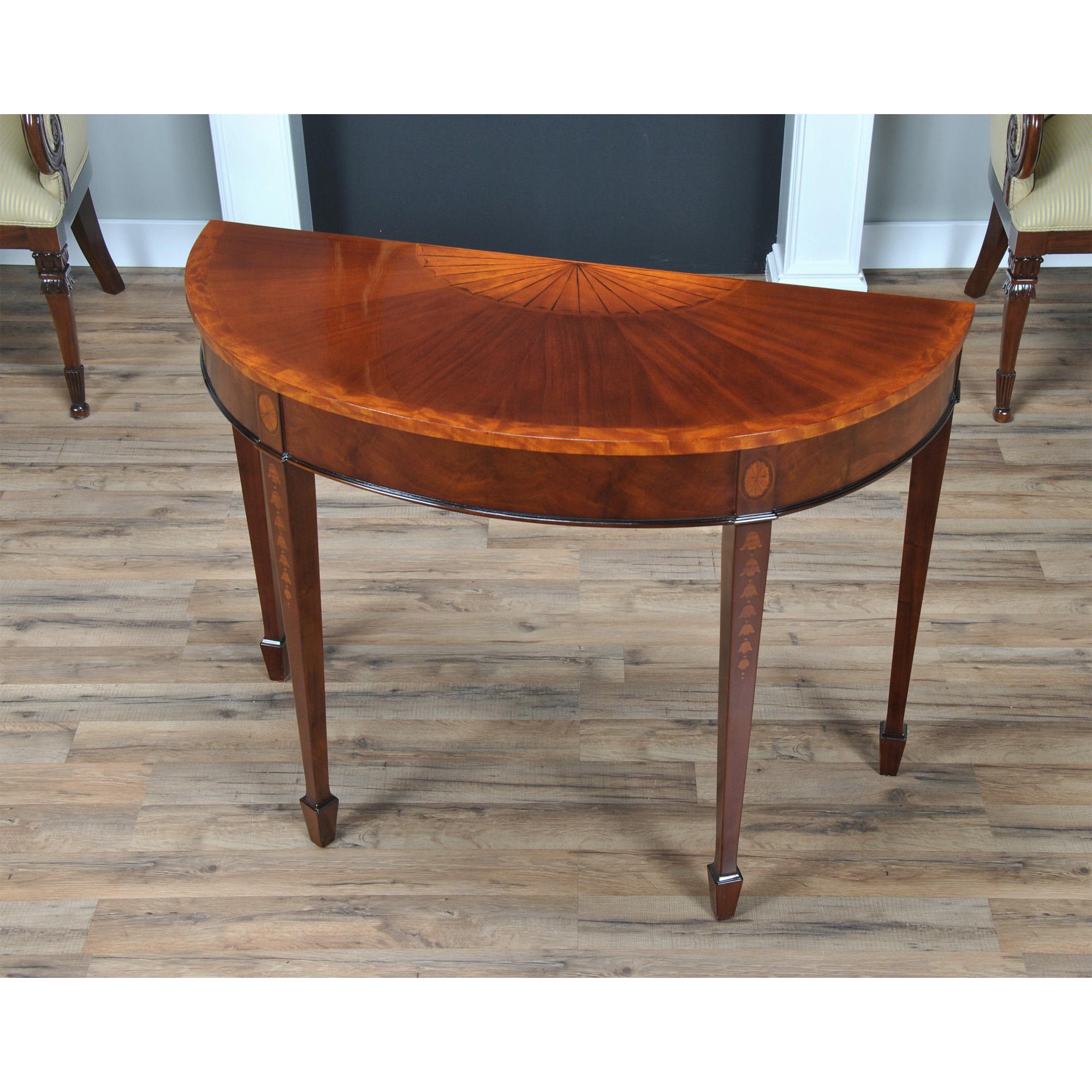 A high quality Mahogany Inlaid Sunburst Console table which makes elaborate use of hand cut inlays. The mahogany top is banded with satinwood and features a sunburst style inlay in the center, the four legs at the apron have oval fan shaped inlays