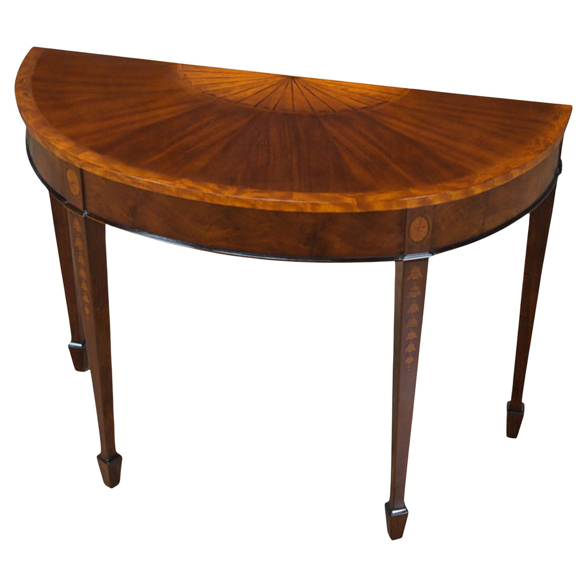 A high quality Mahogany Inlaid Sunburst Console table which makes elaborate use of hand cut inlays. The mahogany top is banded with satinwood and features a sunburst style inlay in the center, the four legs at the apron have oval fan shaped inlays