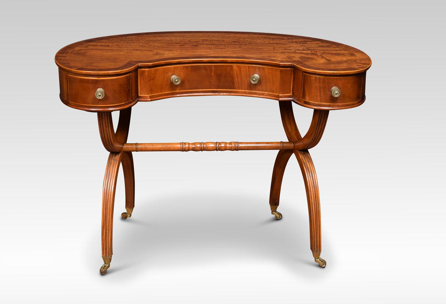 Mahogany lady’s dressing table the kidney shaped crossbanded top, above three freeze drawers. Raised on `X` shaped supports terminating in brass castors
Dimensions:
Height 28 inches
Width 39.5 inches
Depth 23 inches.