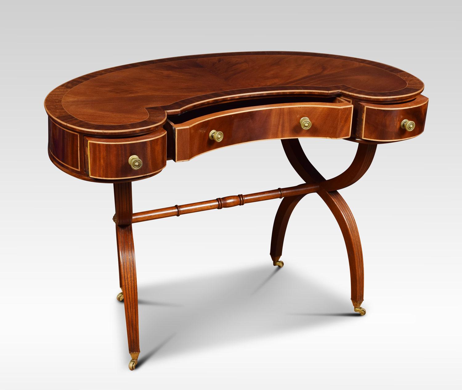 Mahogany ladies dressing table the kidney shaped crossbanded top, above three freeze drawers. Raised on 'X' shaped supports terminating in brass castors
Dimensions:
Height 28 inches
Width 39.5 inches
Depth 23 inches.