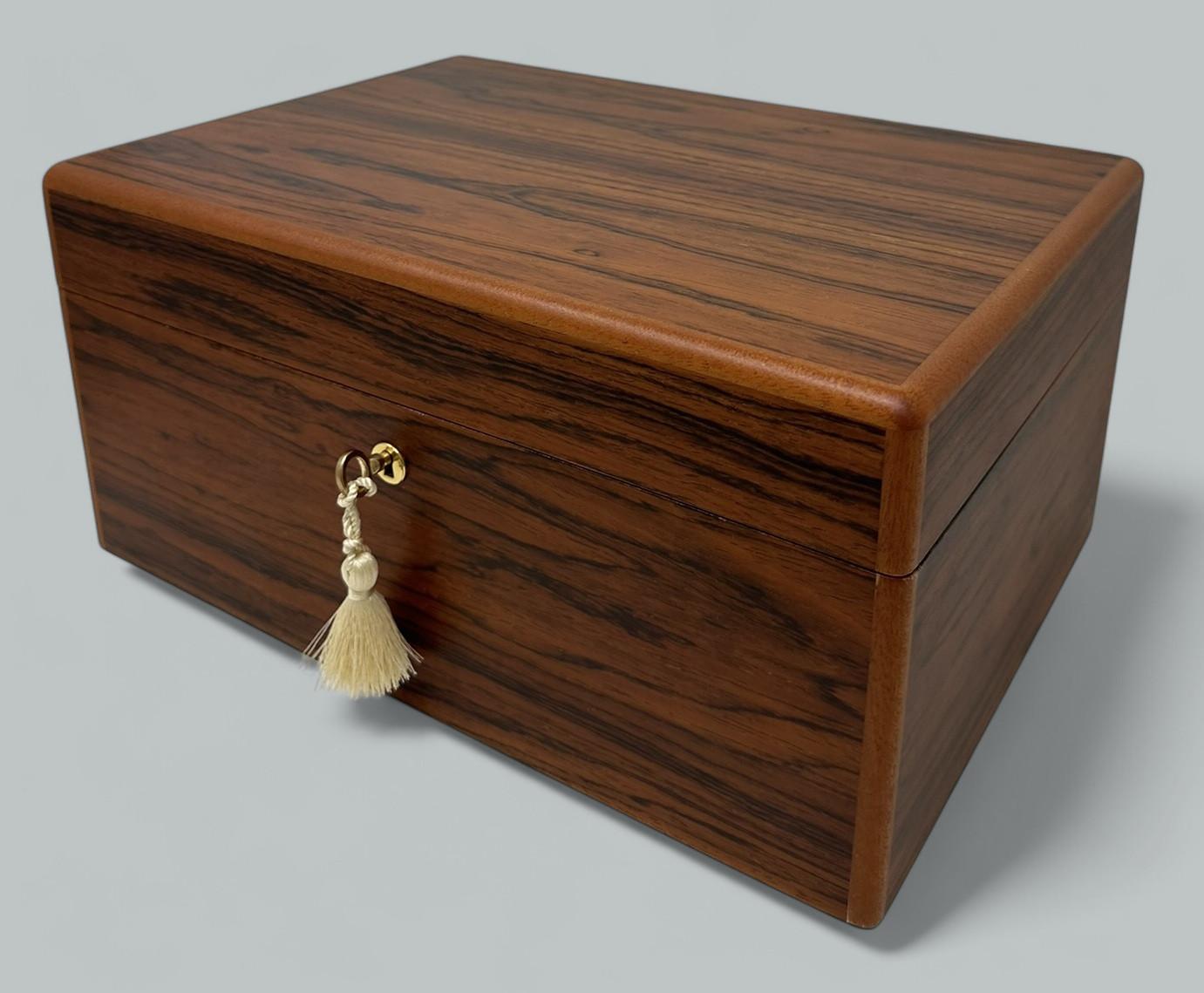 This well figured Mahogany jewellery casket was manufactured by the famed manning of Ireland company and is truly a jewel of handcrafted genius. This box is constructed of the finest woods available and the knowledge and skill of 4 generations of
