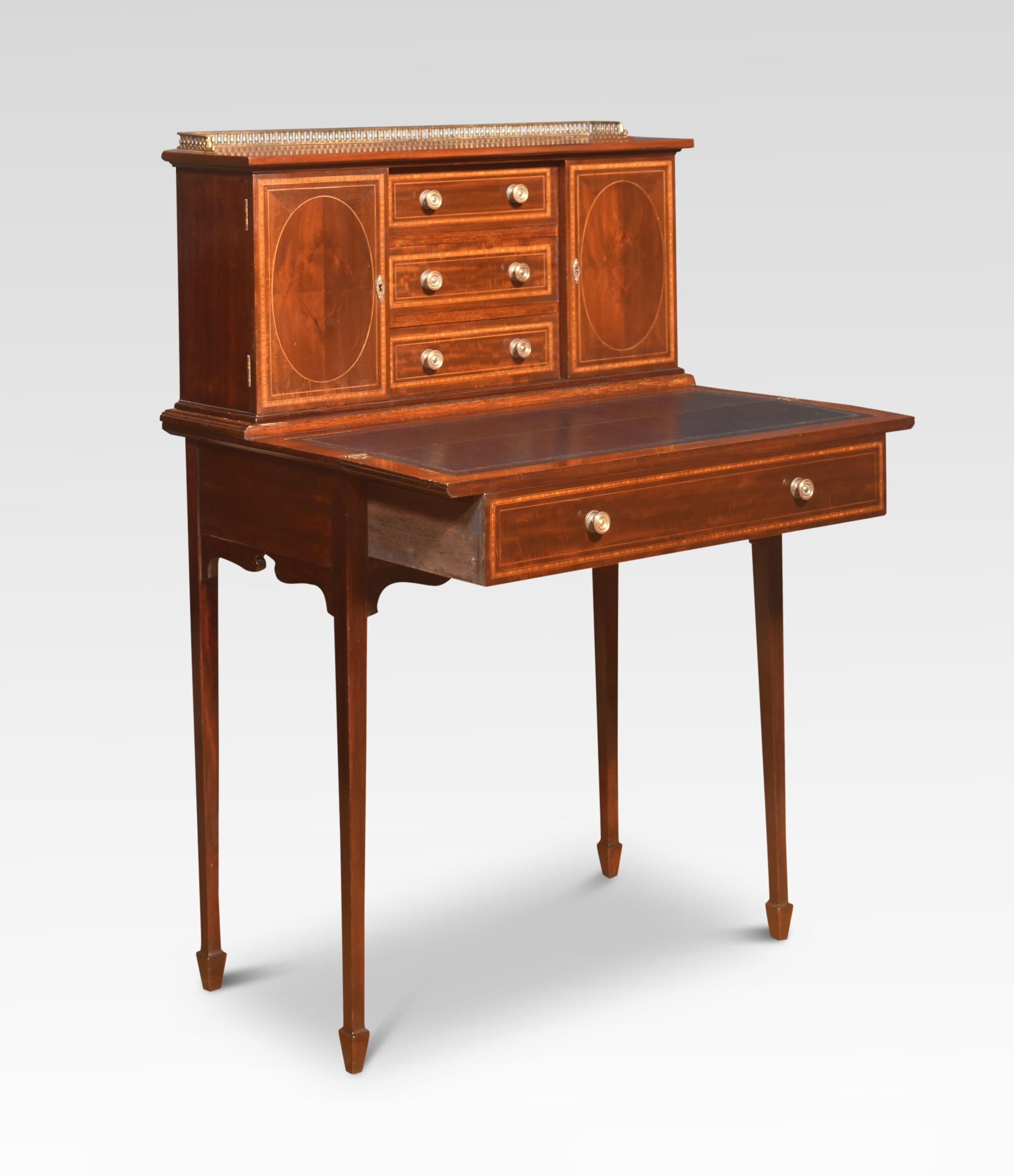 Mahogany and boxwood strung lady`s writing desk, the raised three quarter gallery above three drawers flanked by cupboards to the fold over replaced blue leather writing service. The base section fitted with one long drawer raised up on square